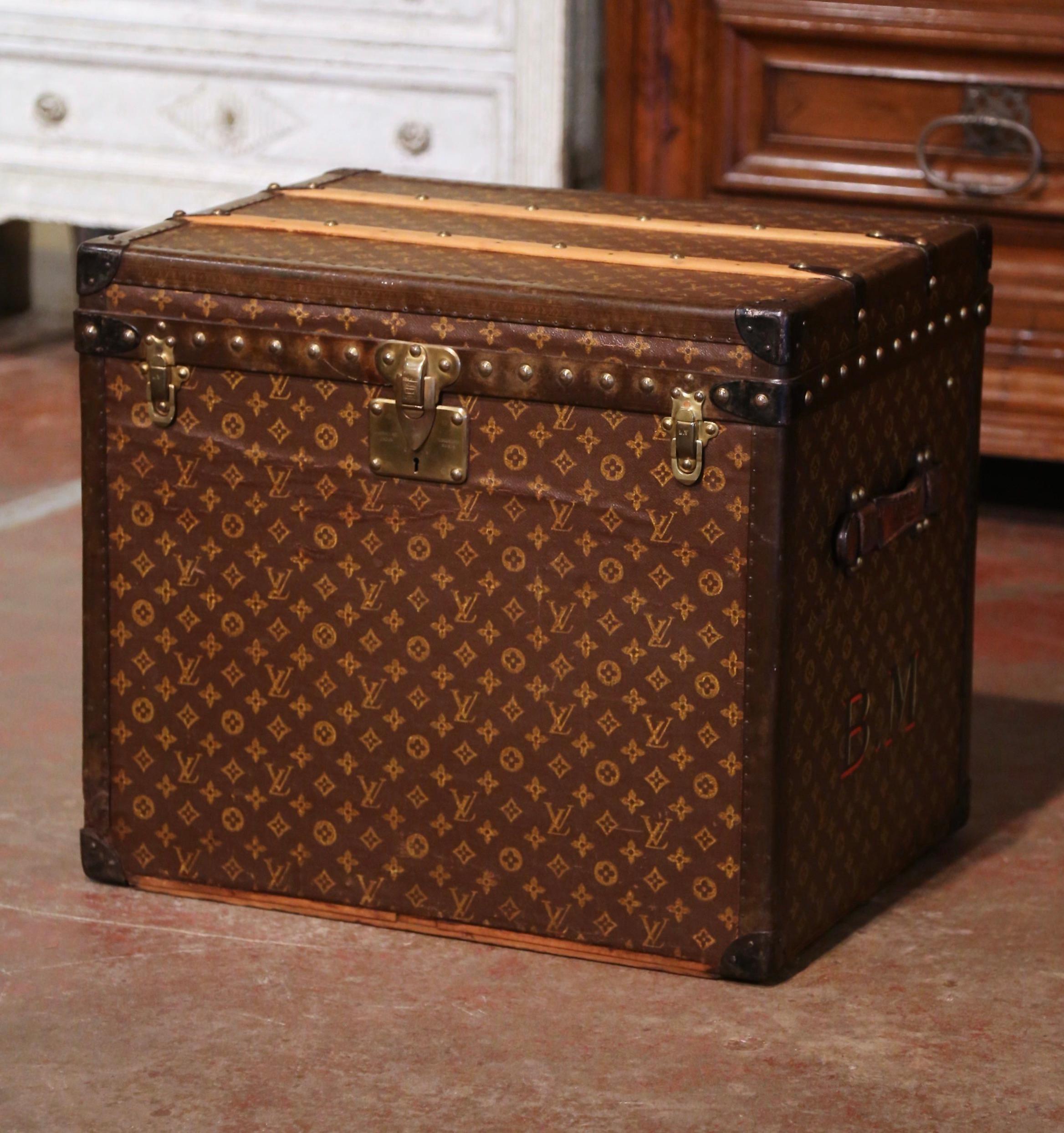 Decorate a den or living room with this antique trunk as a coffee table. Crafted in France by Louis Vuitton circa 1920, the decorative Vuitton hat trunk 