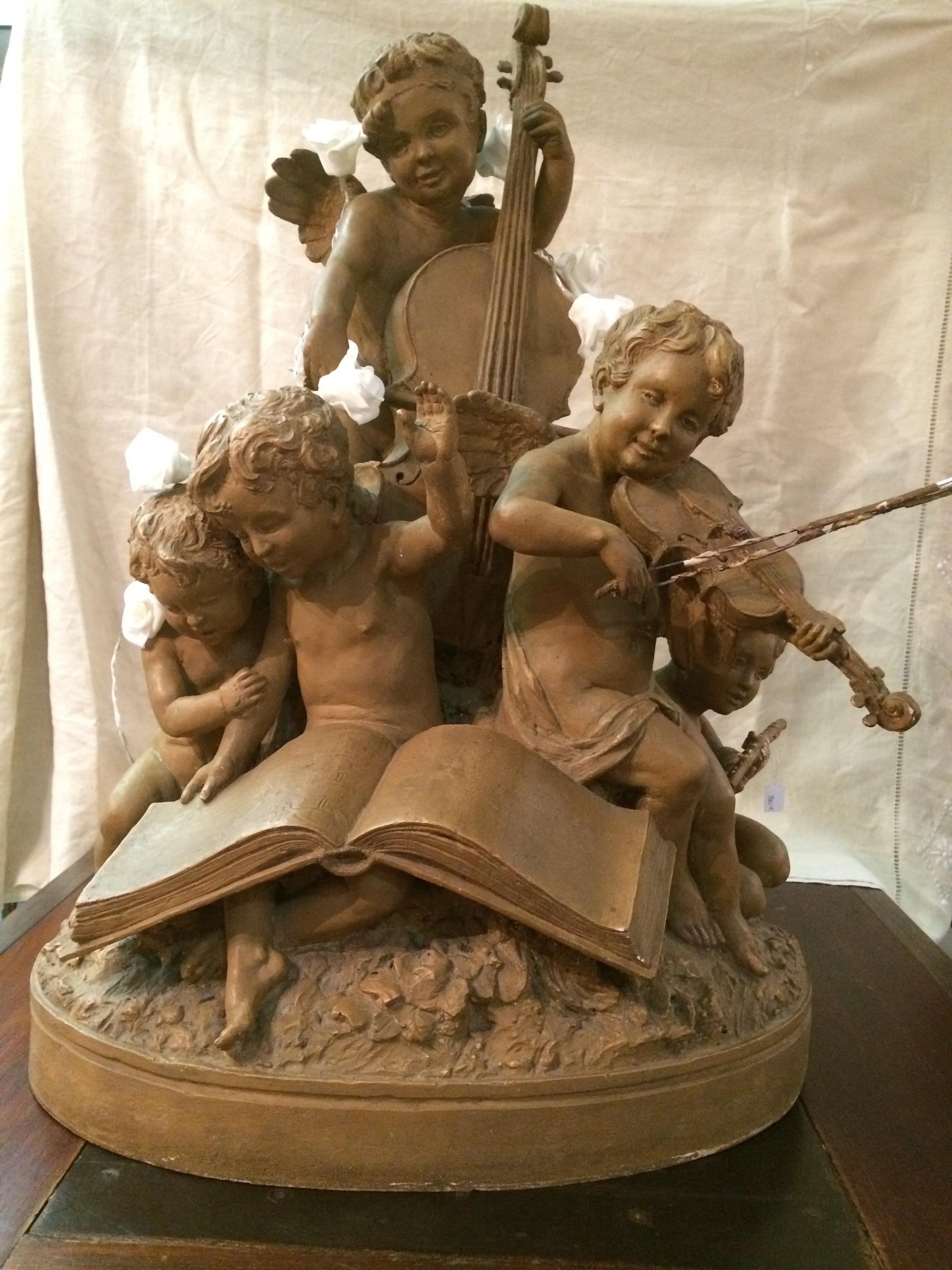 20th century French terracotta musician children angels statue signed by Guillaume Claude Henry Delaspre 1948. Artist of the French school of the first part twentieth century. The violin bow is damage, there is a lack of terracotta. 
Very delicate