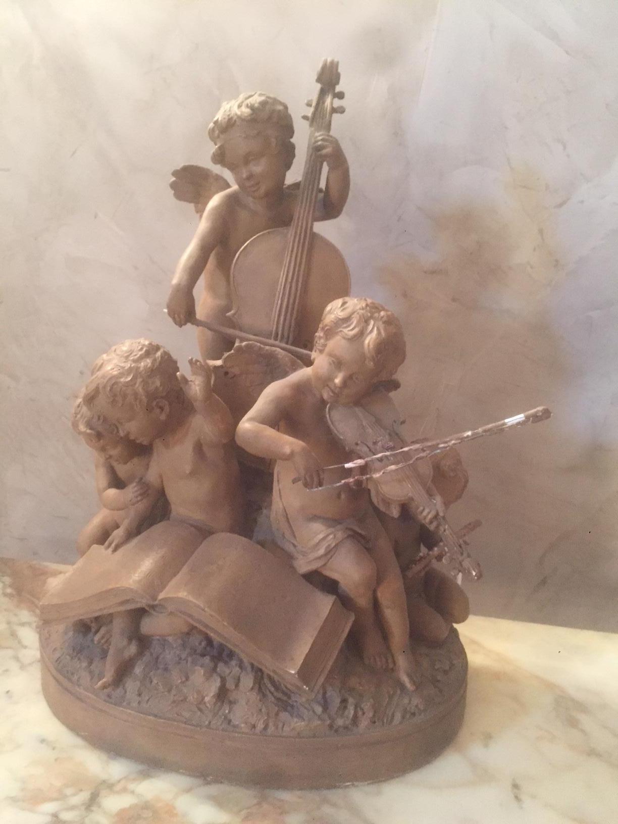 Very nice early 20th century French terracotta musician children sculpture.