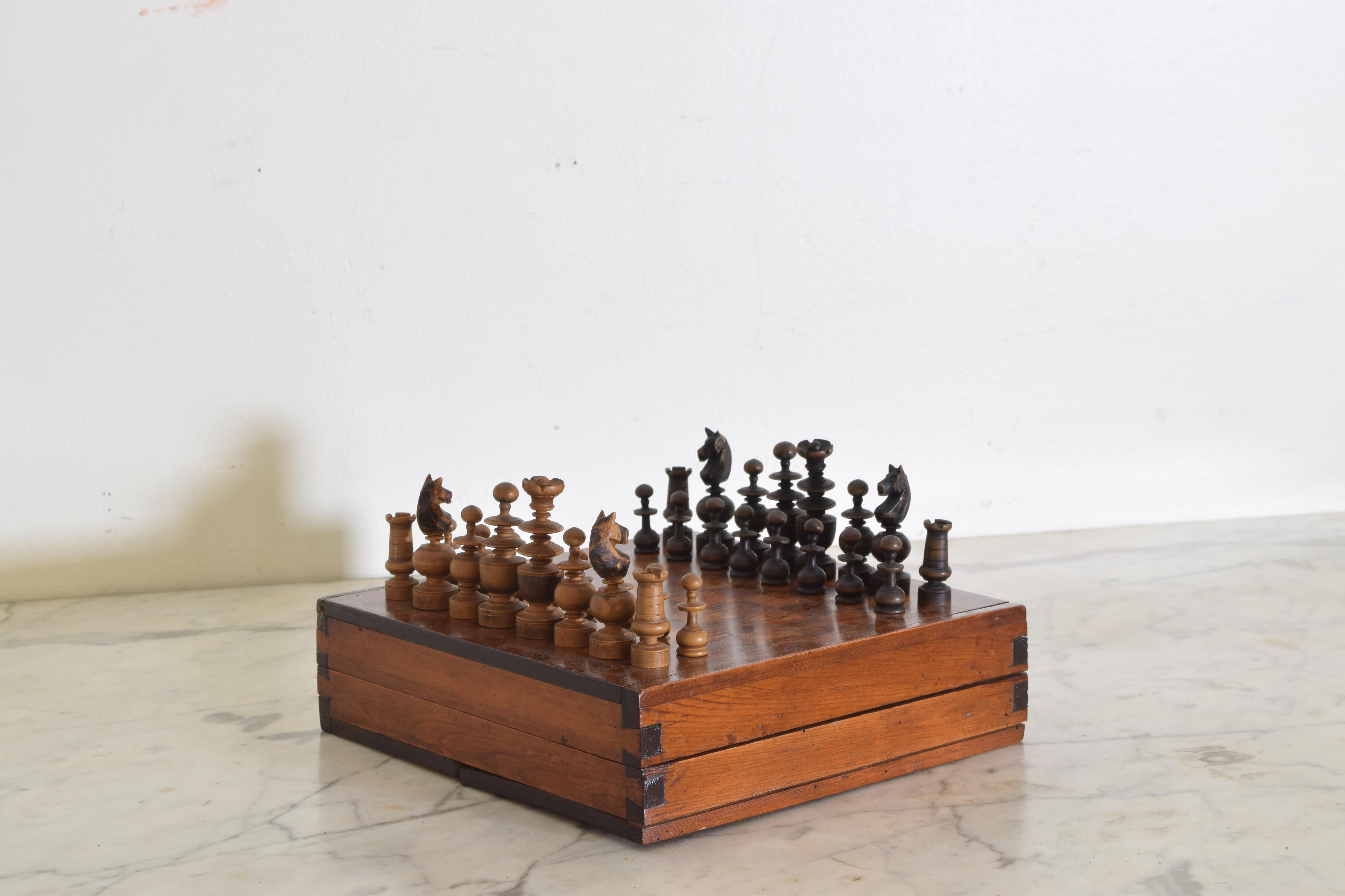 Hand carved and crafted chess set with dovetail joints, veneered playing board, and brass hinges.