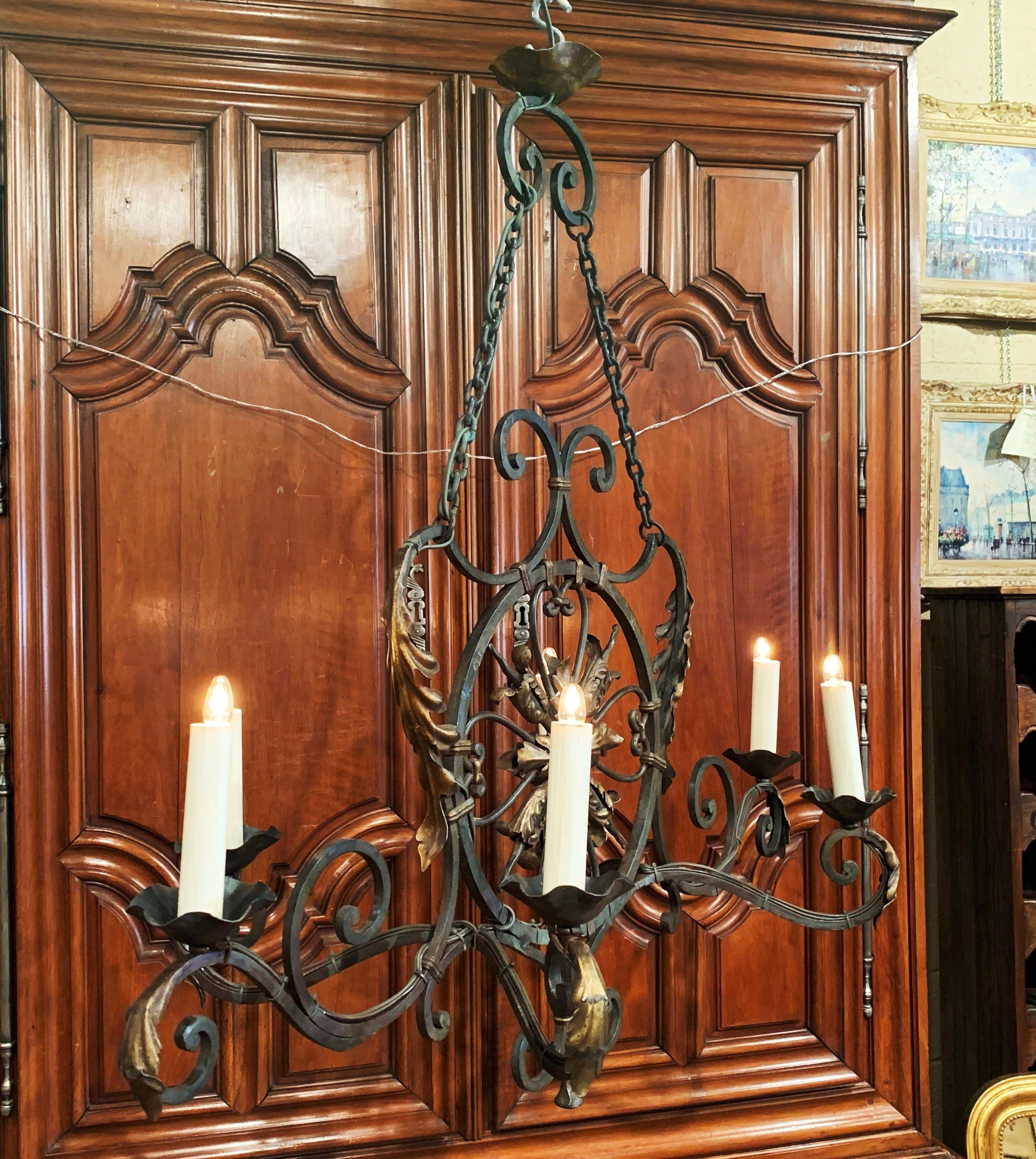 Bring some country French flair to your breakfast room with this large oblong light fixture. Crafted in France circa 1920, the antique chandelier has six arms embellished with decorative metal acanthus leaves on each arm. The fixture features a