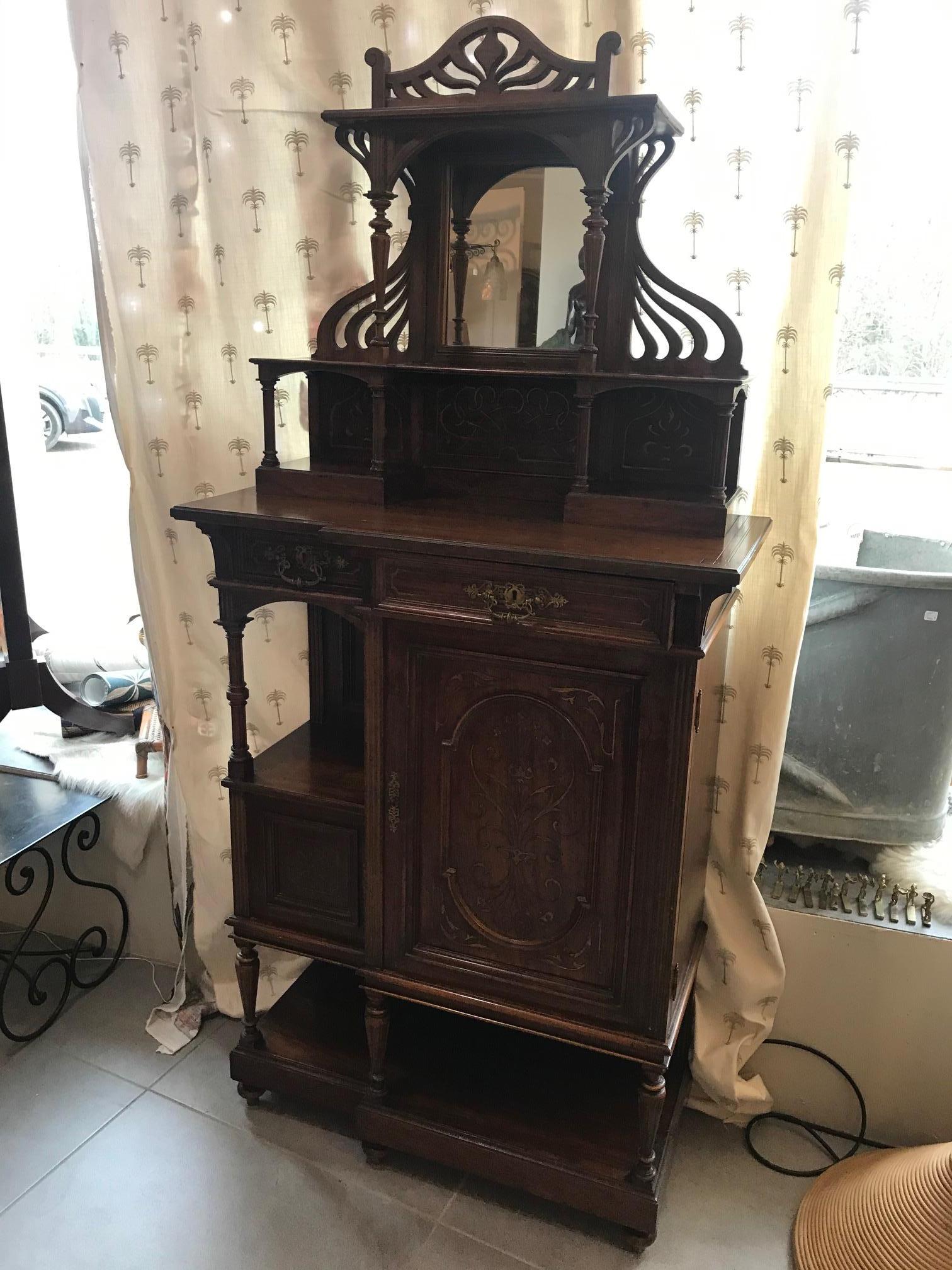 Very nice early 20th century French walnut Art Nouveau cabinet from the 1900s.
Glass in the middle. Beautiful Art Nouveau curves.
Two drawers and one-door with shelves. Gilt brass handles.
Nice quality and good condition.