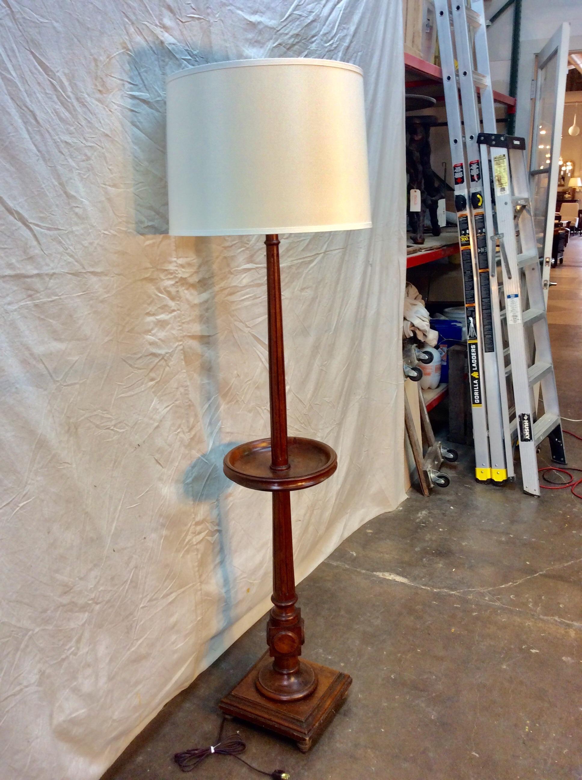 Found in the South of France, this early 20th century French Walnut Floor Lamp featrues a carved and fluted column resting on square base that is supported by four turned feet. Constructed with a half height table, this piece has been professionally