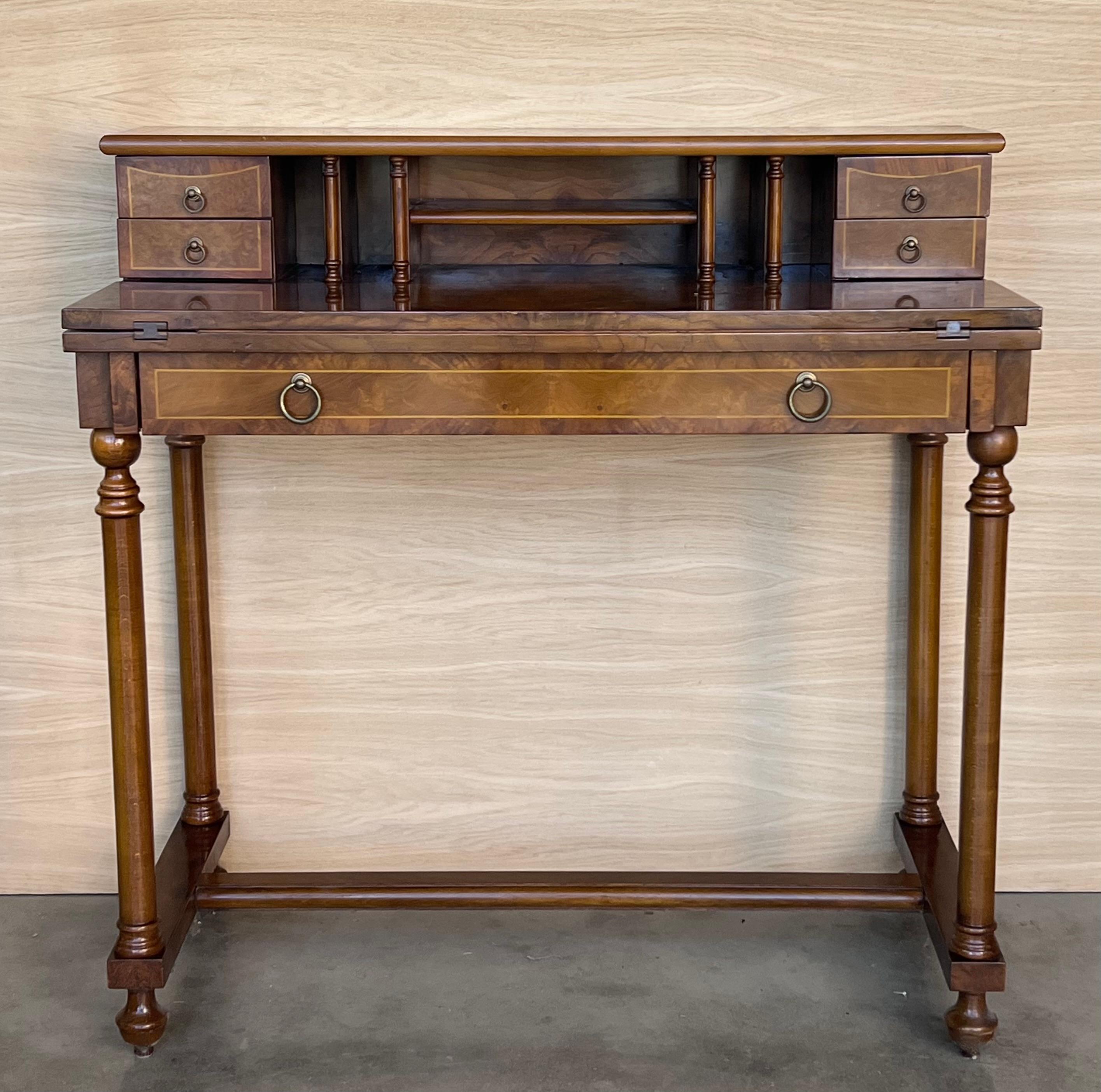 20th Century French walnut veneer and marquetry dressing table with wooden drawers crest and bronze handles.
