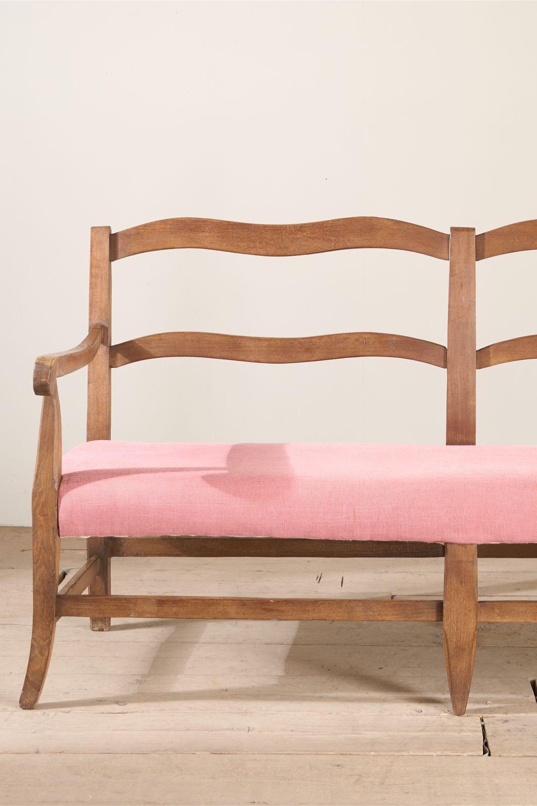 This is an effortlessly elegant early 20th century French hall bench. The wavy back rest and the splayed legs are stunning. This is recently upholstered (not by us) but clean to be used as is or we can recover if you prefer. The patina to the timber