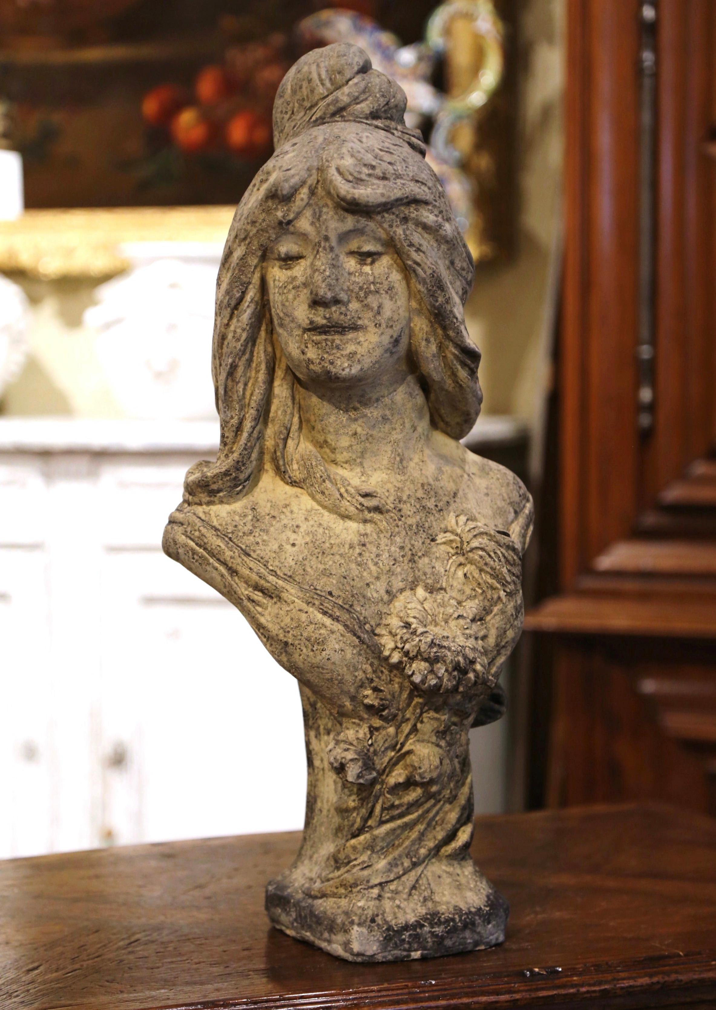 Decorate a garden or patio with this elegant antique outdoor statue. Carved of stone in France circa 1930, the figure stands on a flared square base and depicts a young woman bust, Mireille, her head turned; she has long hair arranged in a top knot,