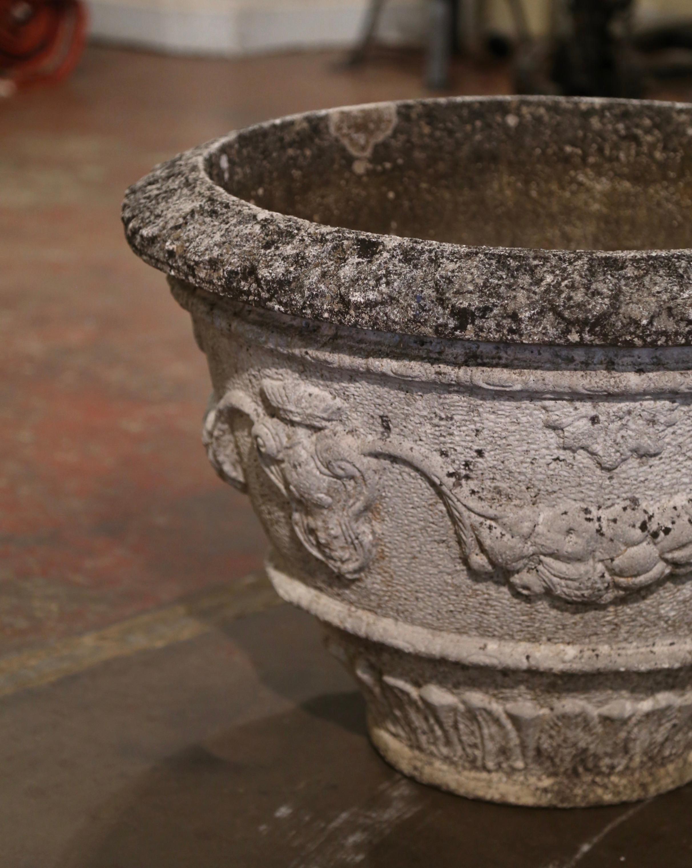 Place this elegant antique stone planter on your patio for a timeless flower display. Crafted in France circa 1920 and built of concrete, the large sturdy jardinière is round in shape embellished with acanthus leaves at the base; it features a wide