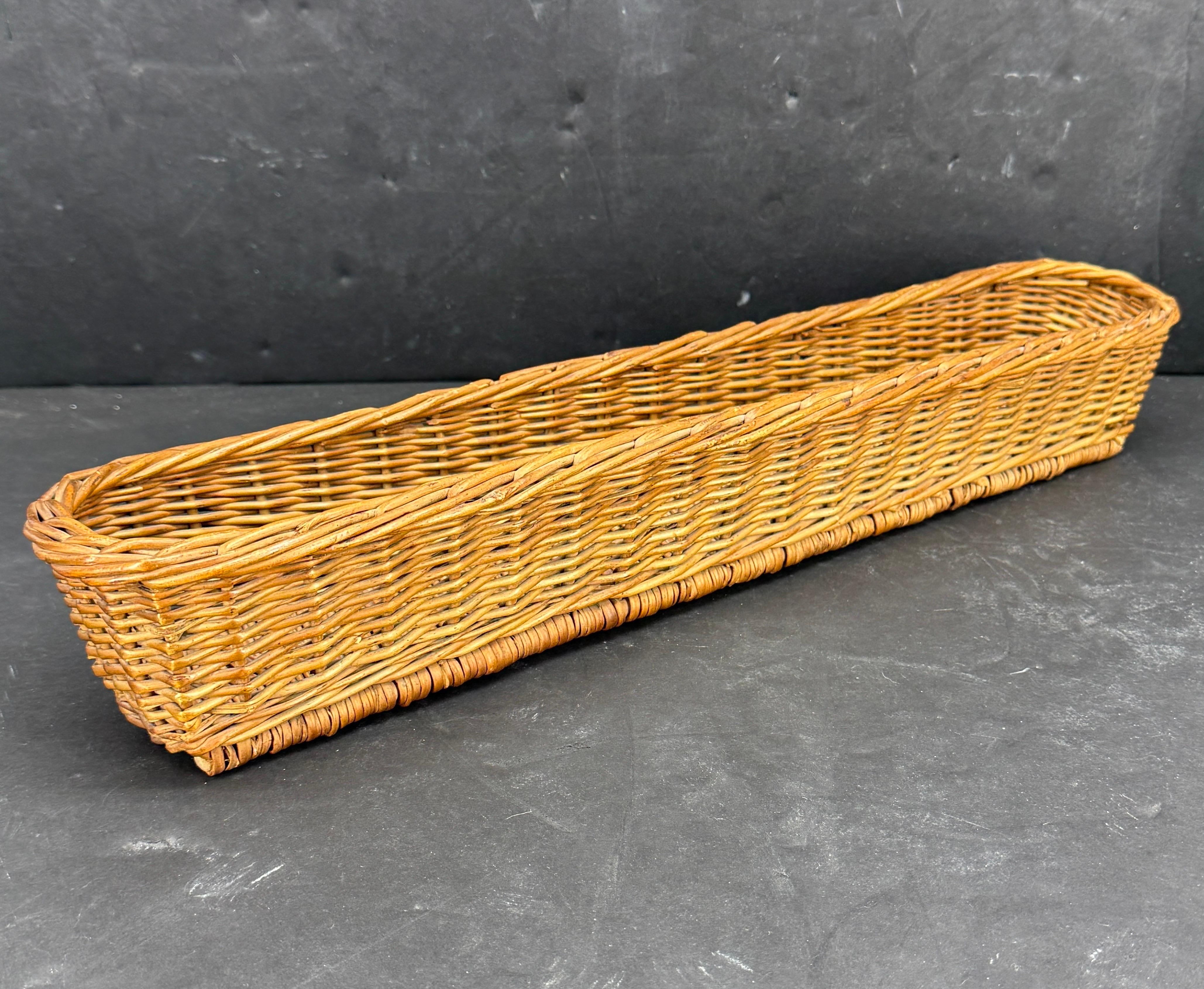 As found in France, a charming narrow French wicker basket. This long basket would look useful on a French table for serving baguettes, bread or even rolls as well as in a kitchen as display. Wonderful patina that only comes with age.