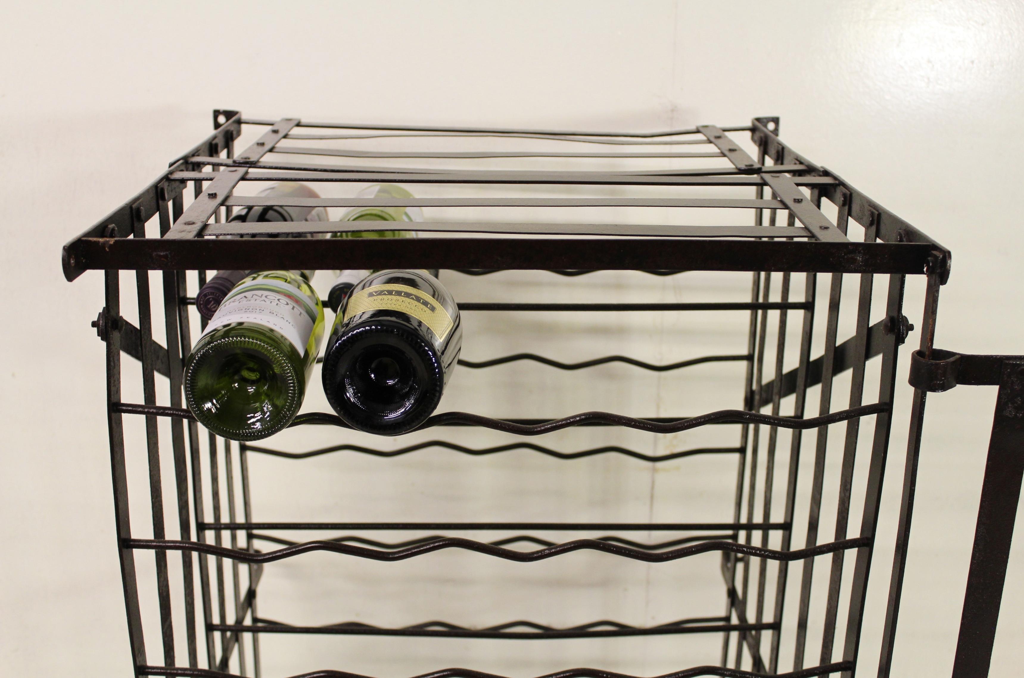 A charming French wine cage with 100 bottle capacity. Made from steel strap-work and with a closing door. Burnished and lacquered in our workshops and now offered for sale in good condition, ready to go straight into the home.