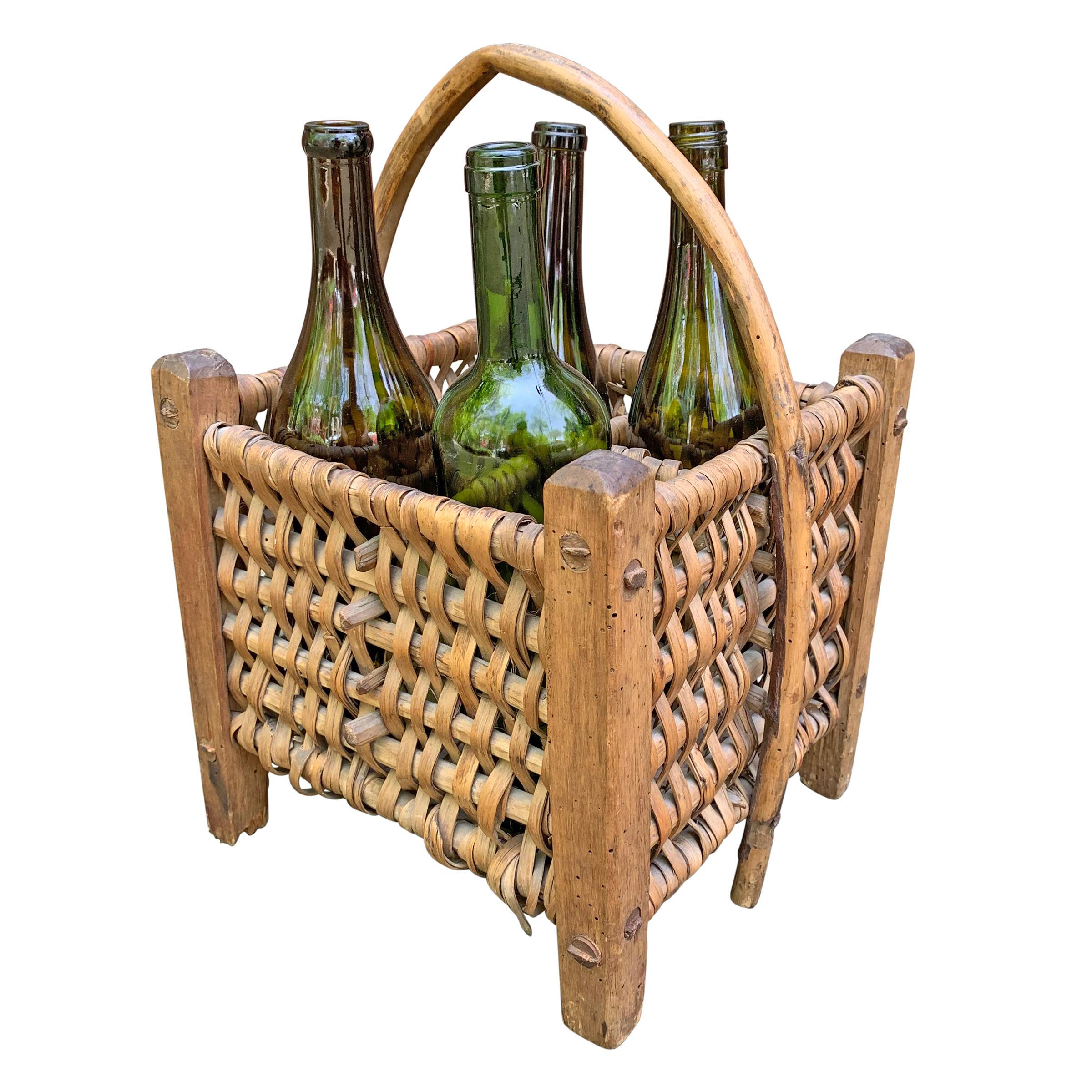 An early 20th century French wine carrier basket originally used to carry bottles from a vineyard cellar to the tasting room.