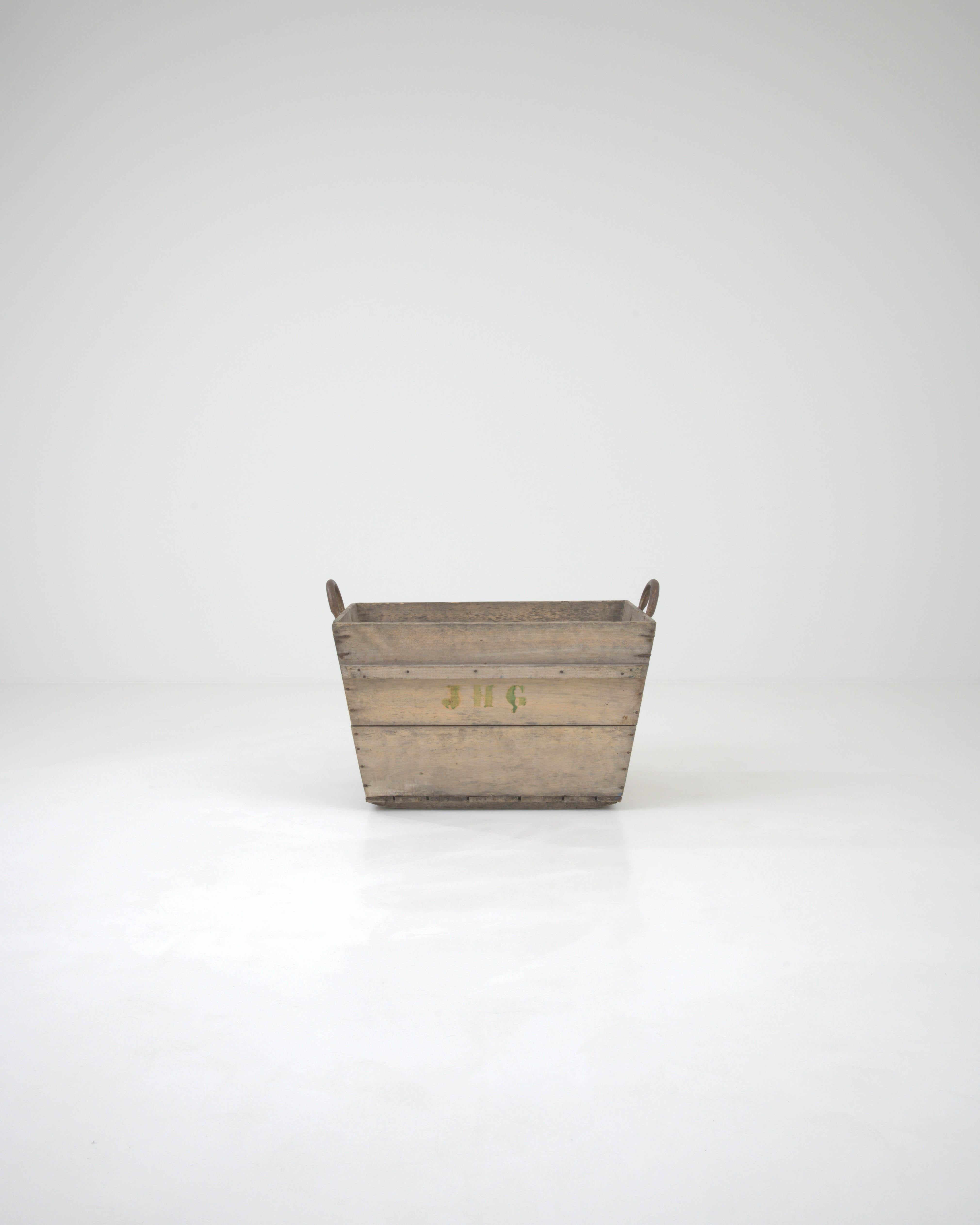 Step into the rustic charm of the French countryside with this authentic Early 20th Century French Wooden Grape Crate. Crafted from solid wood that has aged gracefully, this piece carries with it the spirit of a bygone era of vineyard harvests and