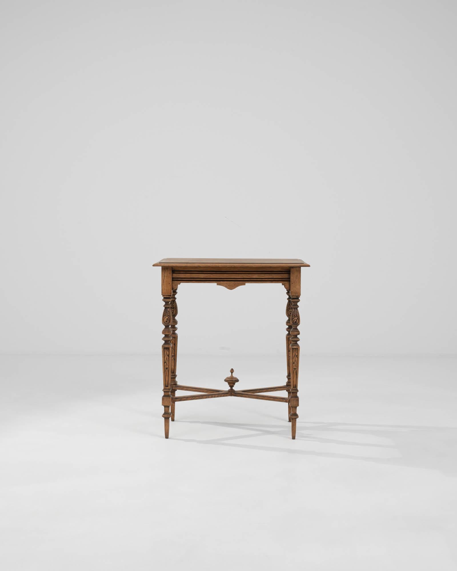 Step back in time with this exquisite Early 20th Century French Wooden Side Table, a classic piece that exudes the grace and charm of a bygone era. Crafted with meticulous attention to detail, this side table showcases masterful carvings, from the
