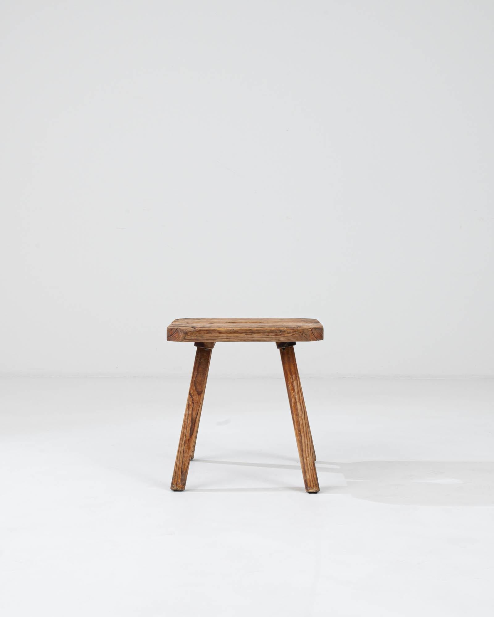 Immerse yourself in the timeless allure of our Early 20th Century French Wooden Stool, a stunning testament to vintage craftsmanship and enduring elegance. Crafted from warm-toned wood in a singular hue, this stool exudes a sense of cozy simplicity,