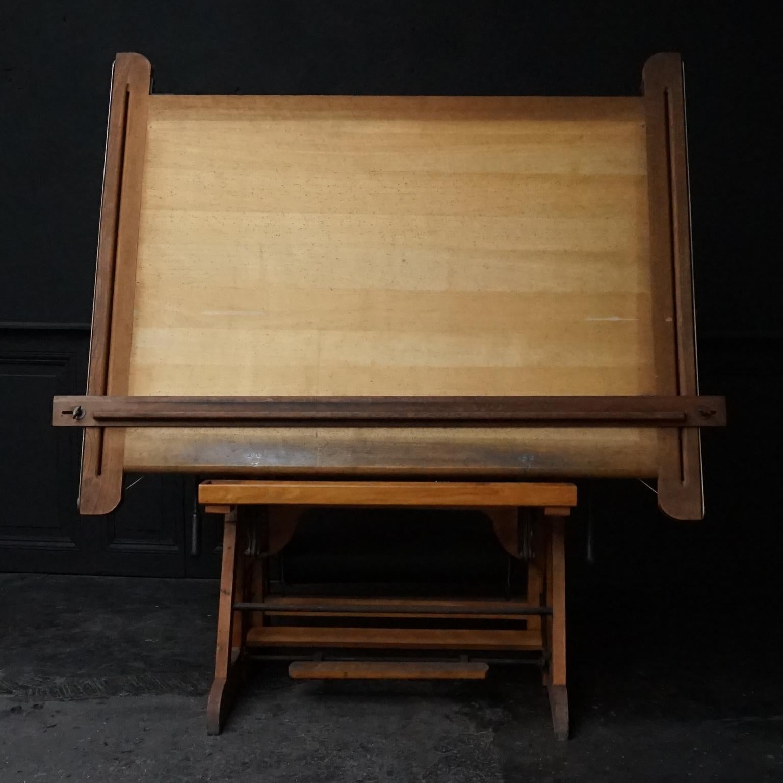 This unique very heavy industrial wooden fully tilting architect's drafting table was a pretty exclusive and cool table around the 1920s and it still is!
It changes easily from one position to another and in height by using the levers and the foot