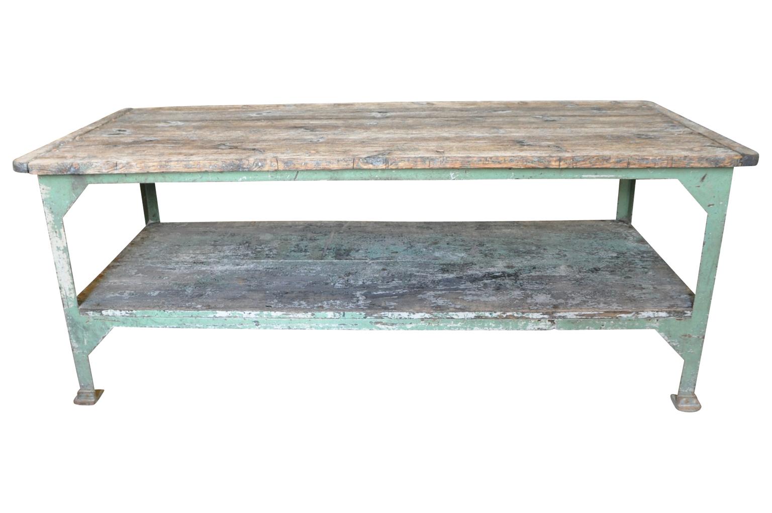 A terrific early 20th century French work table, Draper's table. Very sturdily constructed from painted iron with a wooden top and shelve. Not only great as a work space, but will be fabulous as a kitchen island as well.