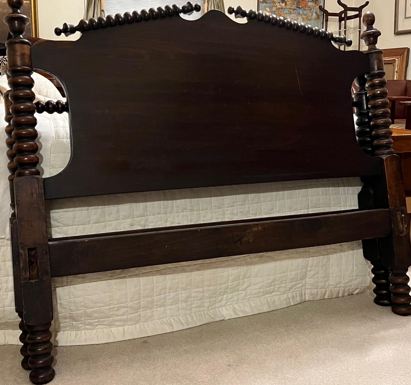 Early 20th C. spool turned Full bed frame in early American style. The wood has a lovely patina and a rich chocolate brown color. The headboard
spool-shaped turnings in the spindles and usually in the rails and posts of the headboard and