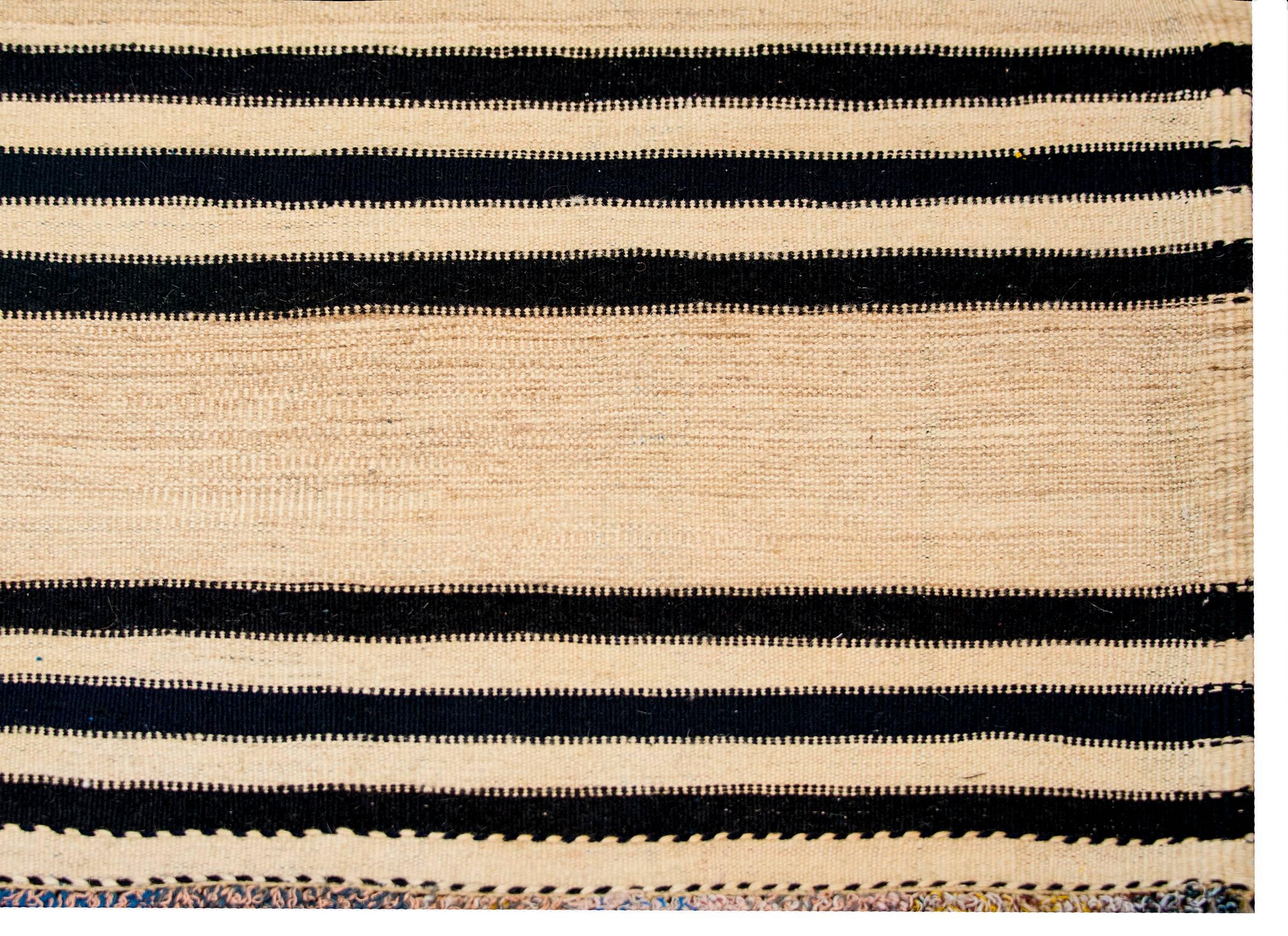 A wonderful early mid-20th century Persian Gabbeh Kilim runner with a bold horizontal stripe pattern with alternating black and natural wool stripes.
 
