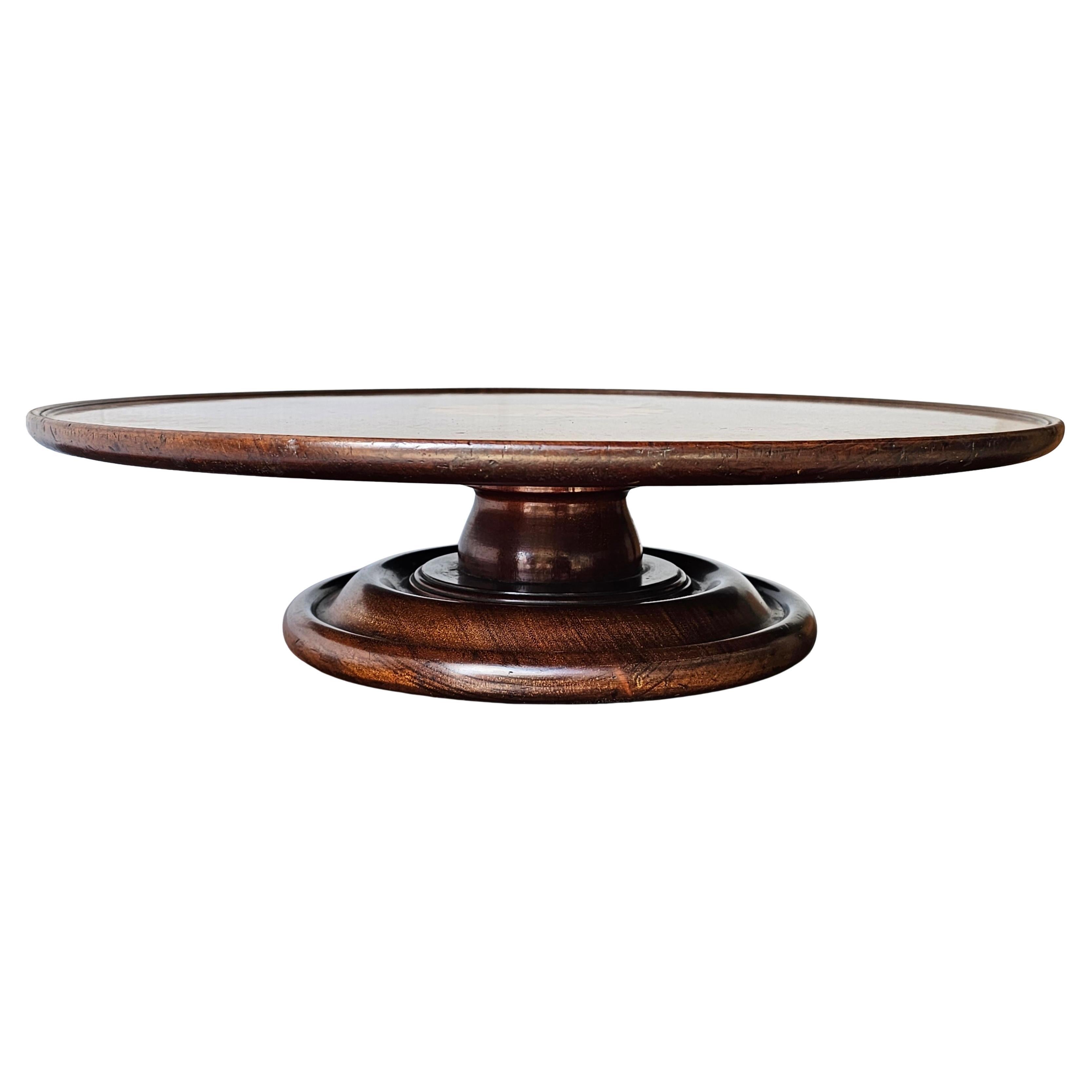 An Inlaid Mahogany Lazy Susan, made in England in the first half of the 20th Century around the 1930s. A Lazy Susan is a round tray that rotates and is designed to sit on a countertop or table and allow multiple diners to access food, condiments and