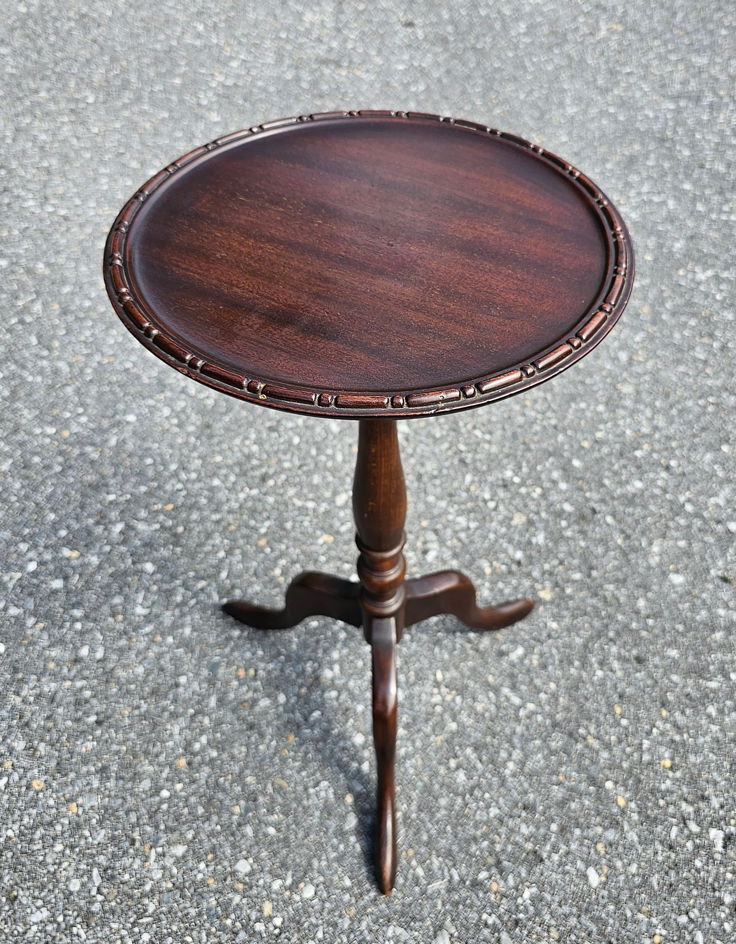 An Early 20th Century refinished Mahogany galleries Pedestal candle stand with finely carved tripod snake feet. Measures 12