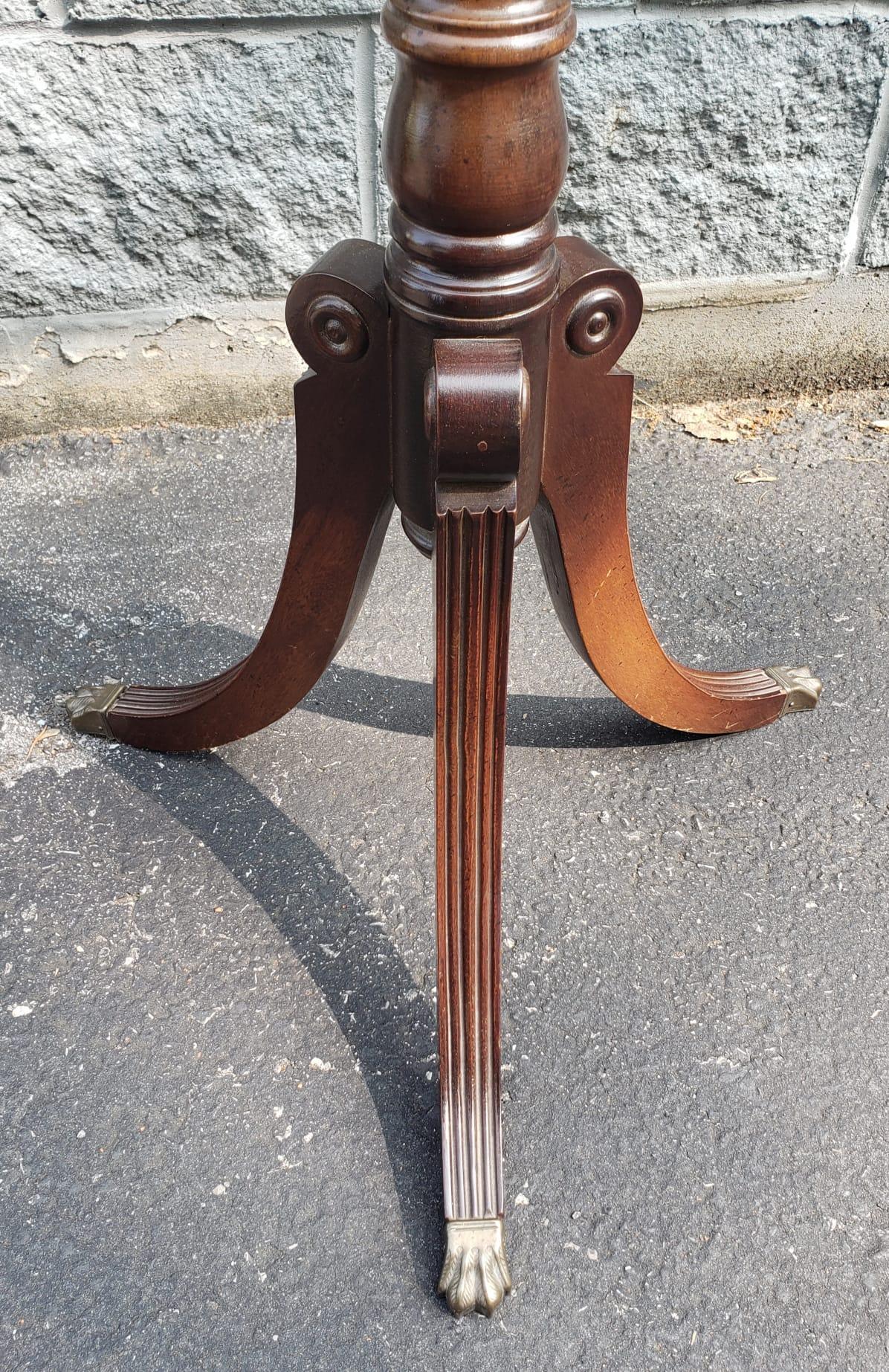 An Early 20th Century Georgian Mahogany Tripod Pedestal Plant Stand with Brass Paw Feet in good condition. 
Measures 14.5