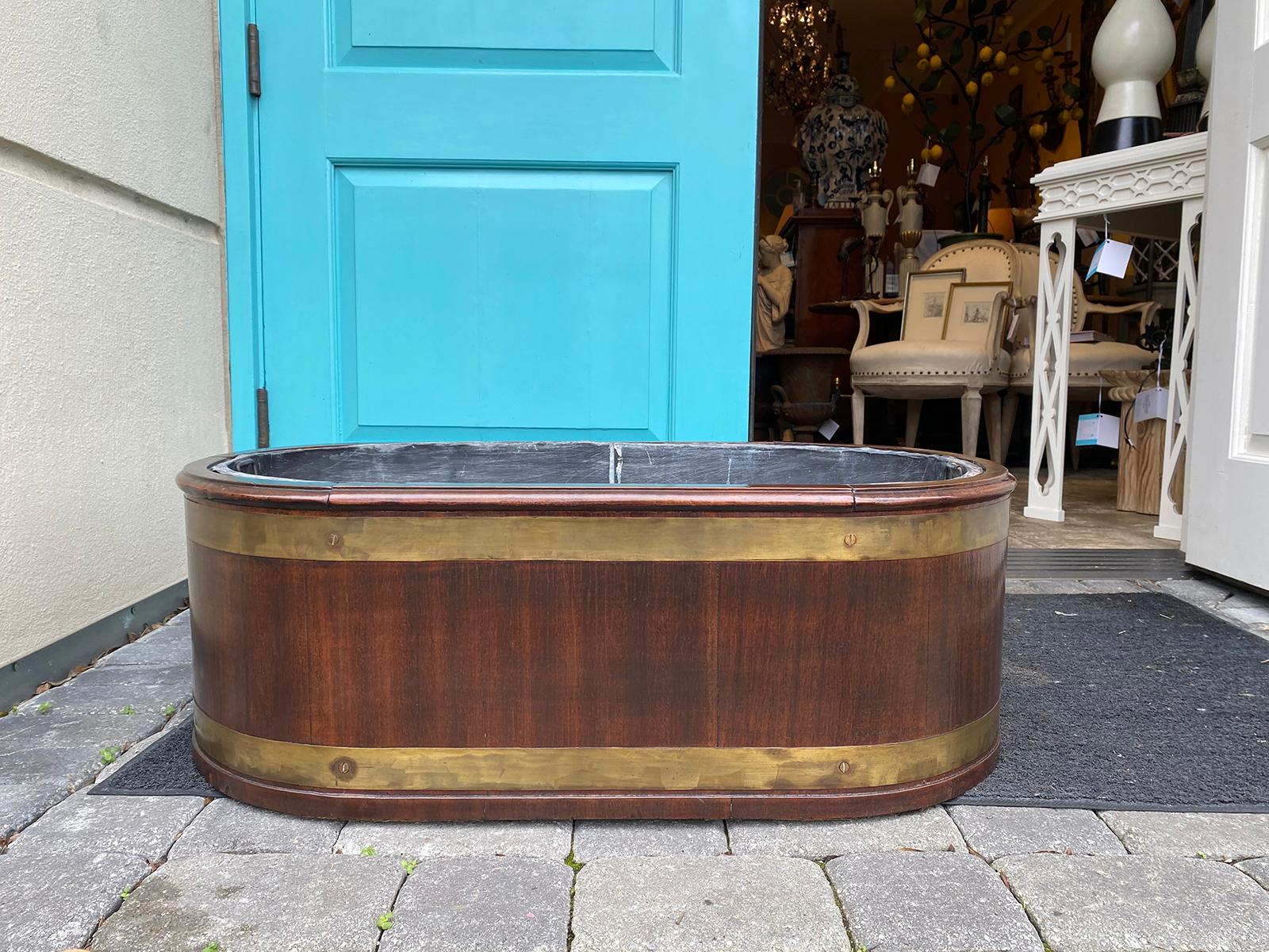 Early 20th century Georgian style brass bound mahogany wine cooler or cellarette with tole insert. Large scale.