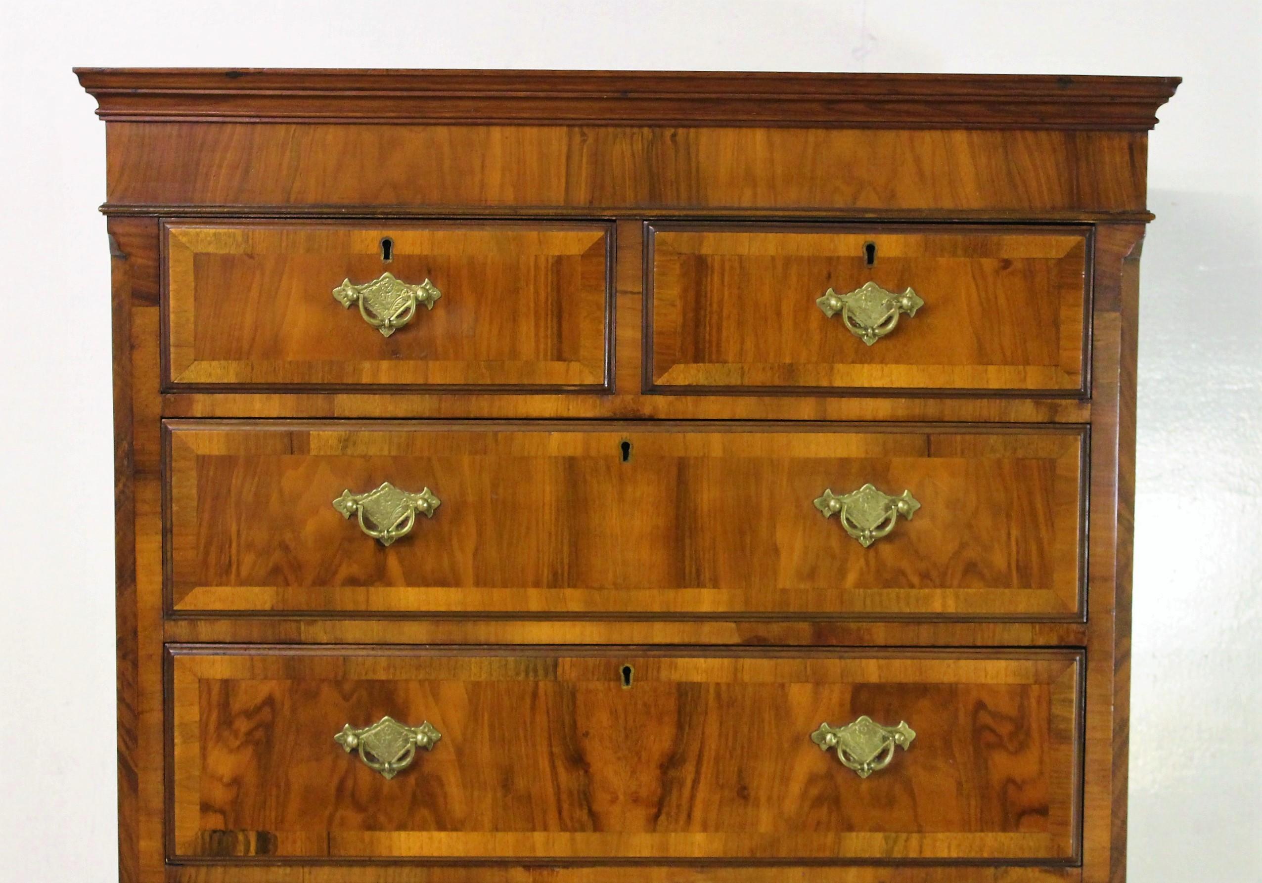 A splendid burr walnut chest on chest, or tallboy, in the early Georgian style. Well constructed in solid walnut with attractive burr walnut veneers onto an oak carcas. The top section with canted corners and an arrangement of 2 short over 3 long