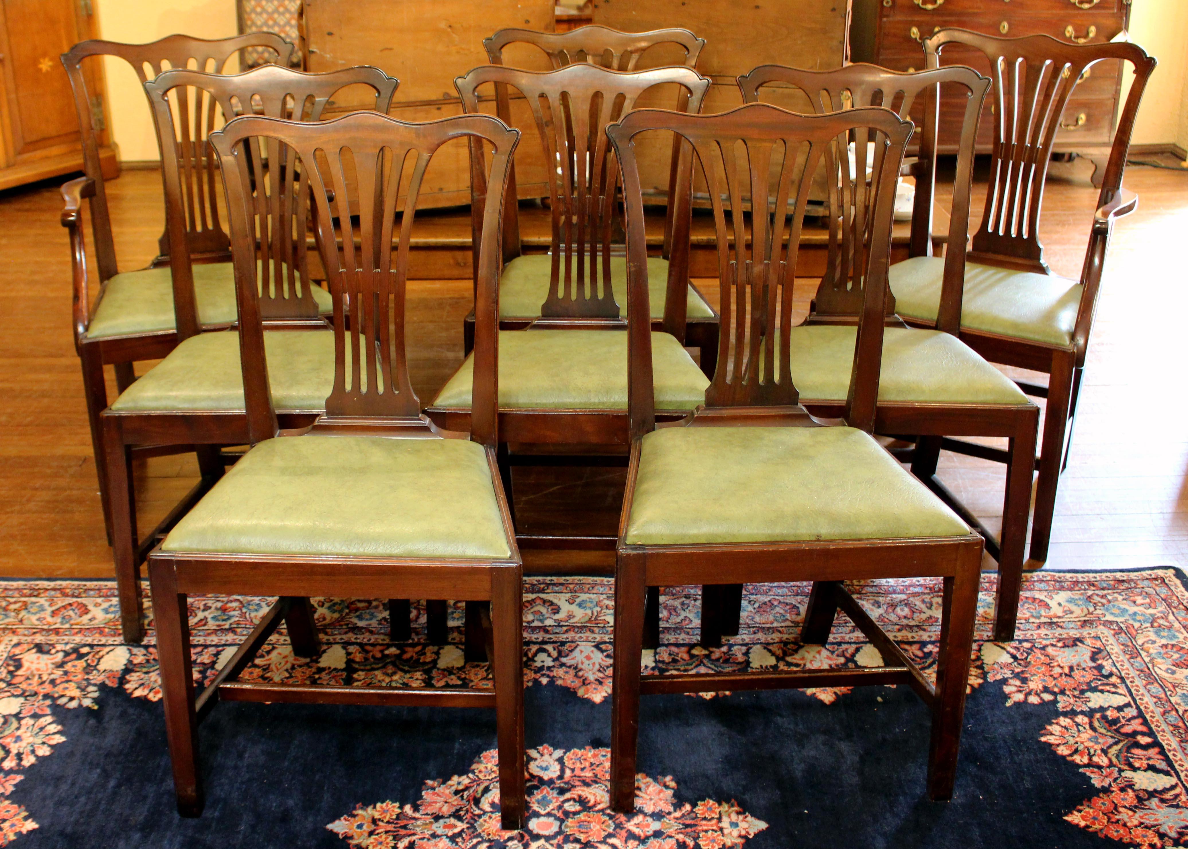 Early 20th century set of eight dining chairs- two arms and six sides. English, Georgian style. London retailer's label. Shaped crest rails; pierced backsplats. Straight, tapered legs. Slip seats. Measures: 23 1/2