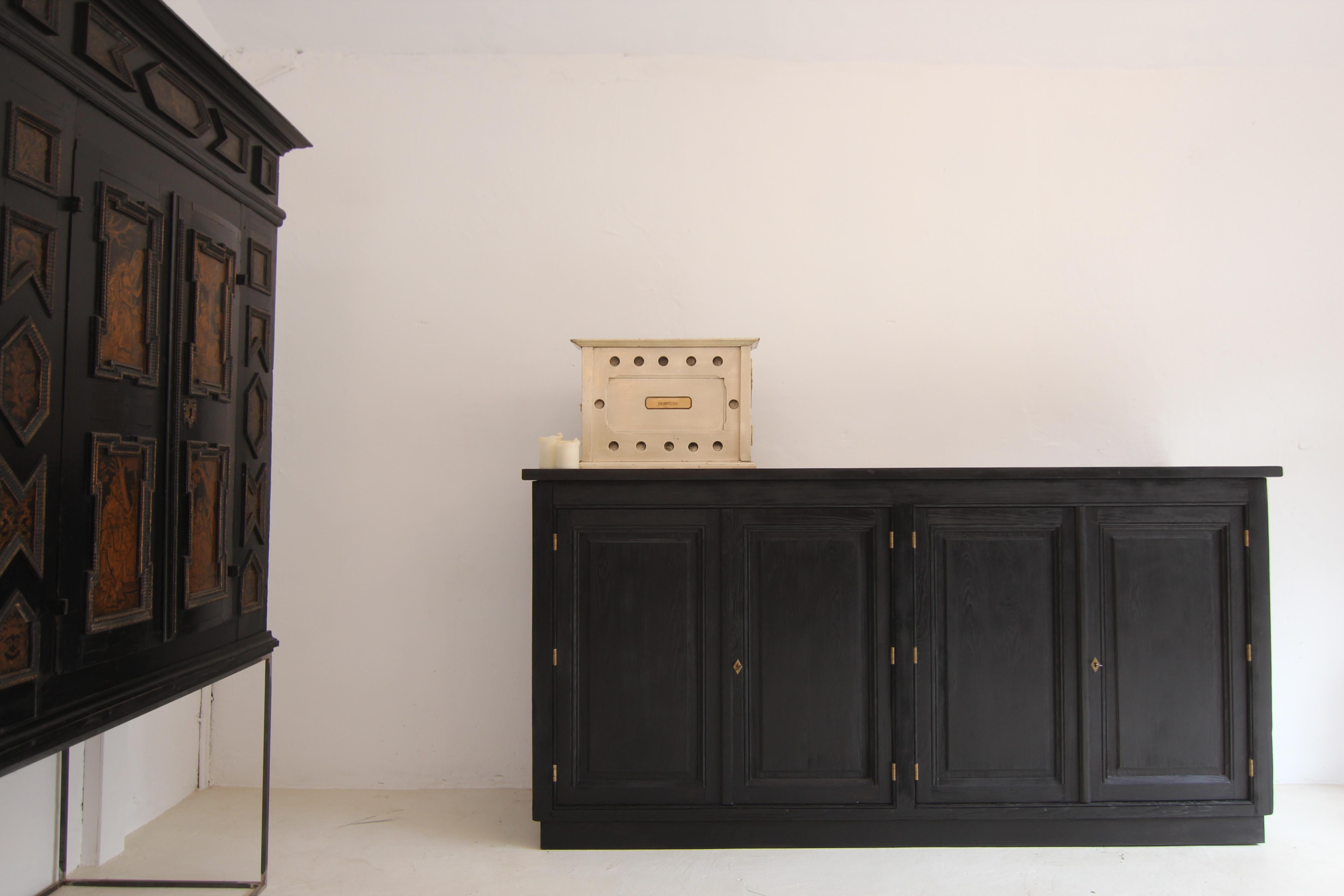 A early 20th century German cheese dairy wall cabinet for practical storage of cheesecloth. Made of pine in original paint with the inscription 