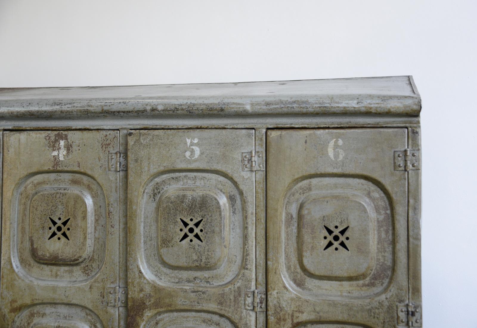 Early 20th century German factory lockers

- Pressed steel with star detail vents
- Original grey paint
- Each locker compartment has 4 hanging hooks and a shelf
- Made by Kuppersbusch
- German, 1900
- Measures: 192 cm tall x 141 cm wide x 40