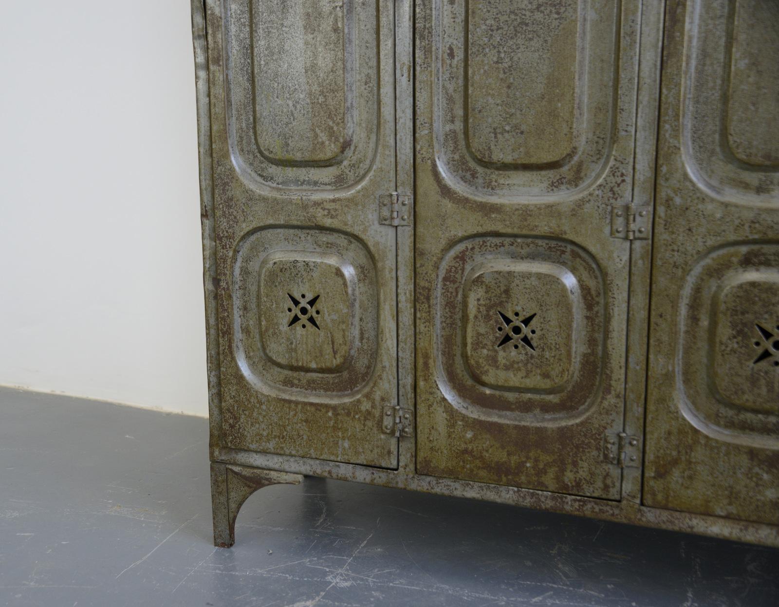 Early 20th century German factory lockers 

- Pressed steel with star detail vents
- Original grey paint
- Each locker compartment has 4 hanging hooks and a shelf
- Made by Kuppersbusch
- German ~ 1900
- Measures: 192cm tall x 141cm wide x