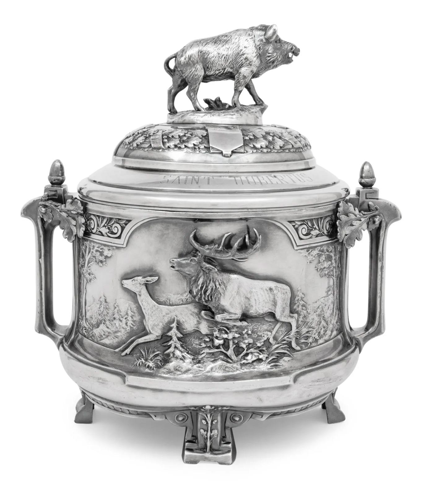 An early 20th century silver-plate tureen from the Saint Hubertus Hunting Lodge, Gelderland, Netherlands. The spacer is engraved with St. Hubertus-Lodge. 

Dimensions: 18