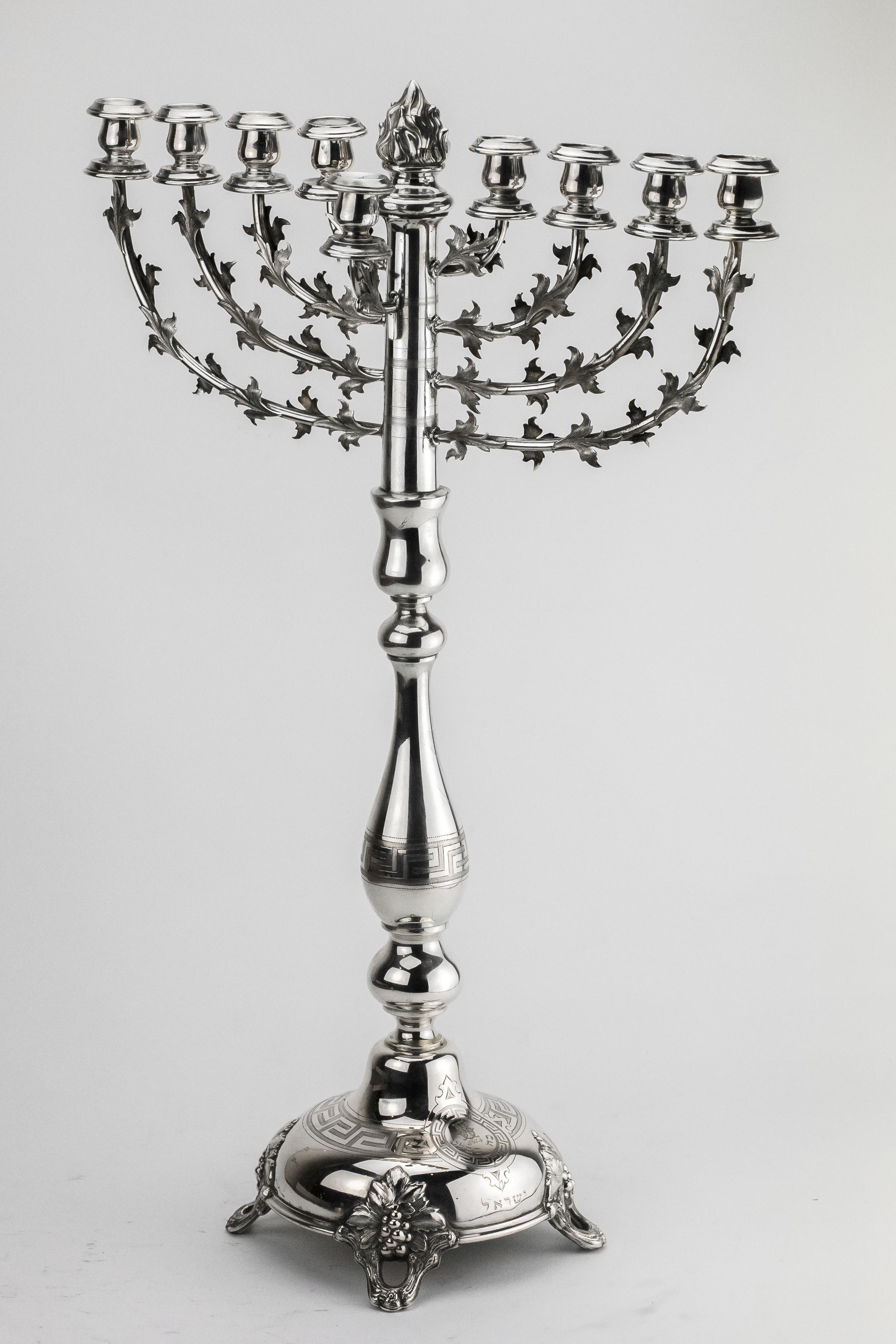 Large synagogue silver Hanukkah Lamp Menorah, Germany, 1914.
This large antique silver Menorah features a baluster form central column with geometrical design using the engraving technique, surmounted by a flame shaped finial, a removable Shamash