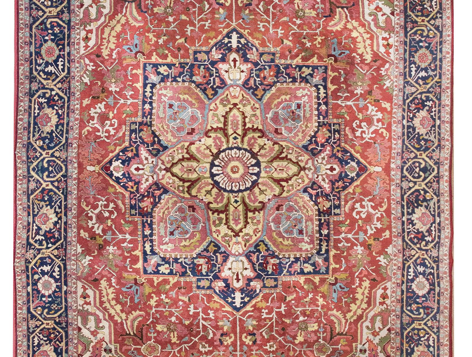 A rare and wonderful early 20th century German Tetex rug woven with a traditional Persian Heriz pattern including a large central floral medallion living amidst a field of more stylized flowers and scrolling vines, surrounded by a wide floral