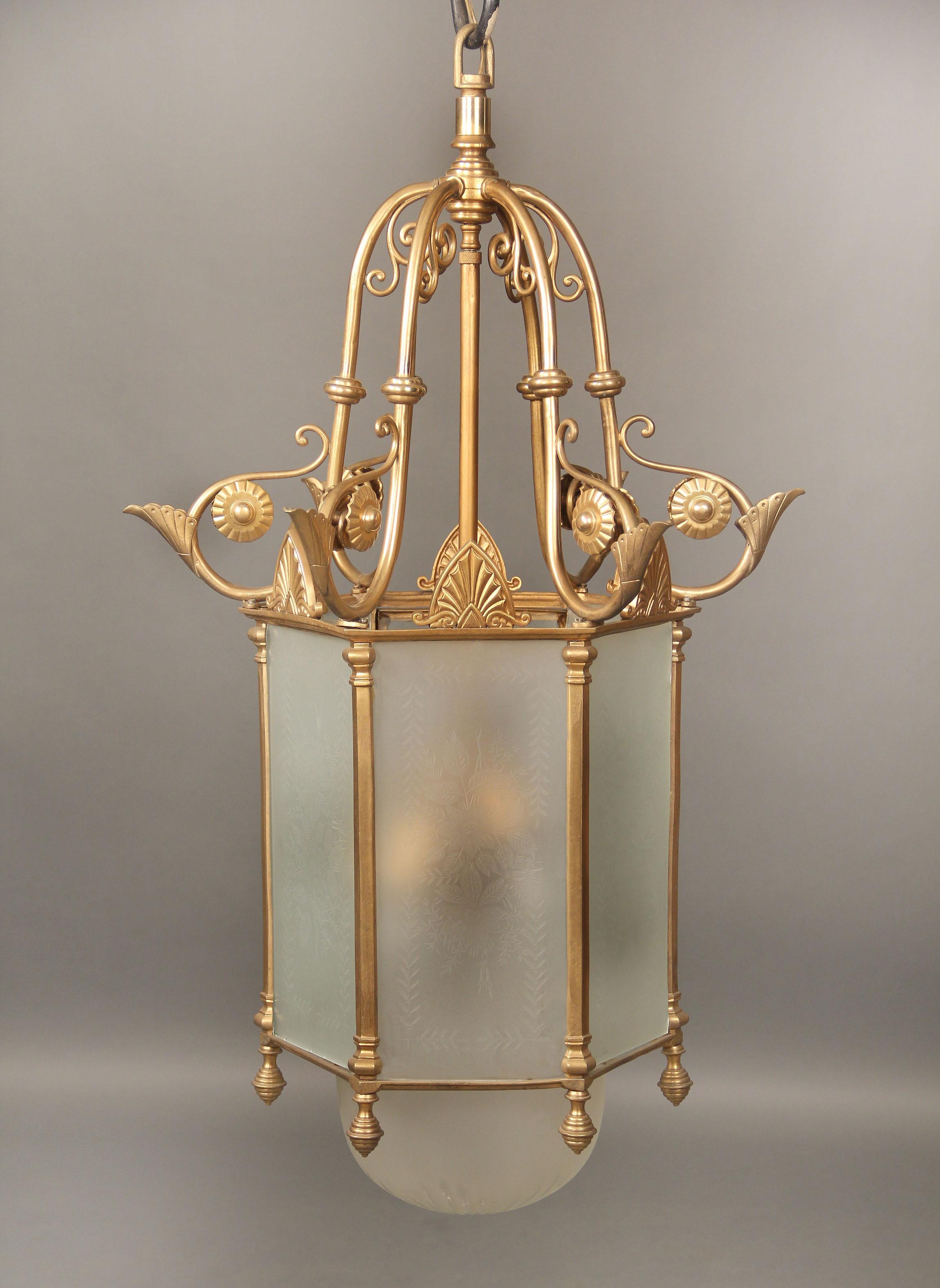 An early 20th century gilt bronze and etched glass lantern

Hexagonal shaped with wonderful etched floral designs on each frosted shade, five interior lights.