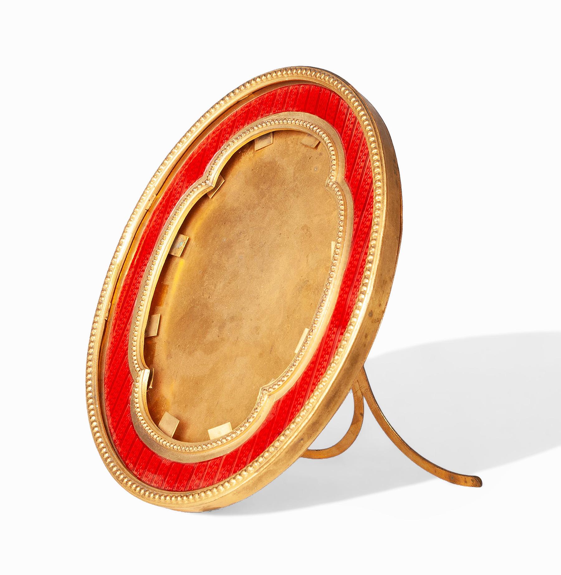 Early 20th century gilt bronze and red enamel wooden oval picture frame with easel back, France

By: unknown
Material: metal, wood, bronze, copper, enamel
Technique: cast, molded, polished, gilt, metalwork, enameled
Dimensions: 1 in x 6 in x 7