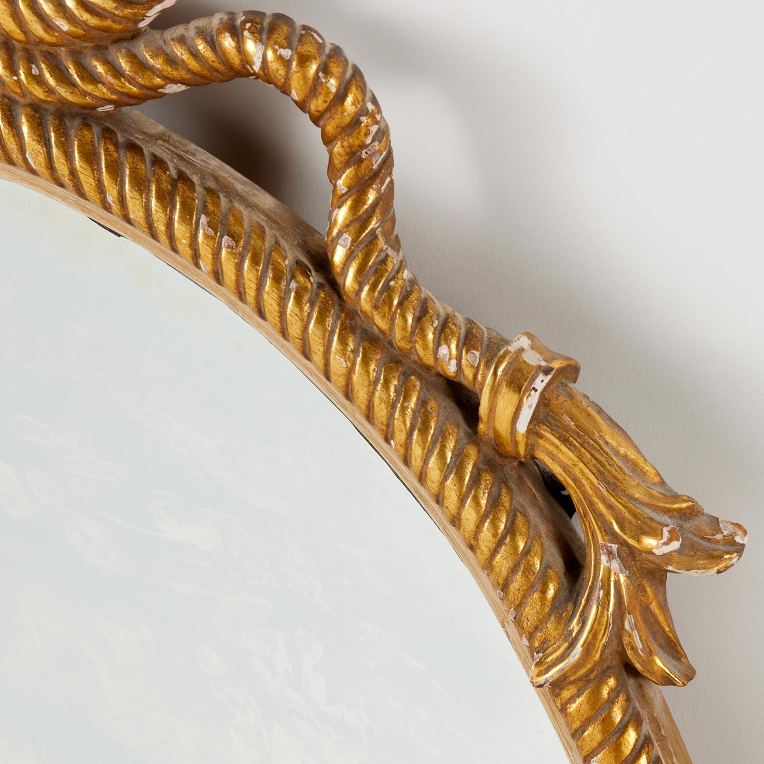 20th c., oval mirror with knotted crests. 