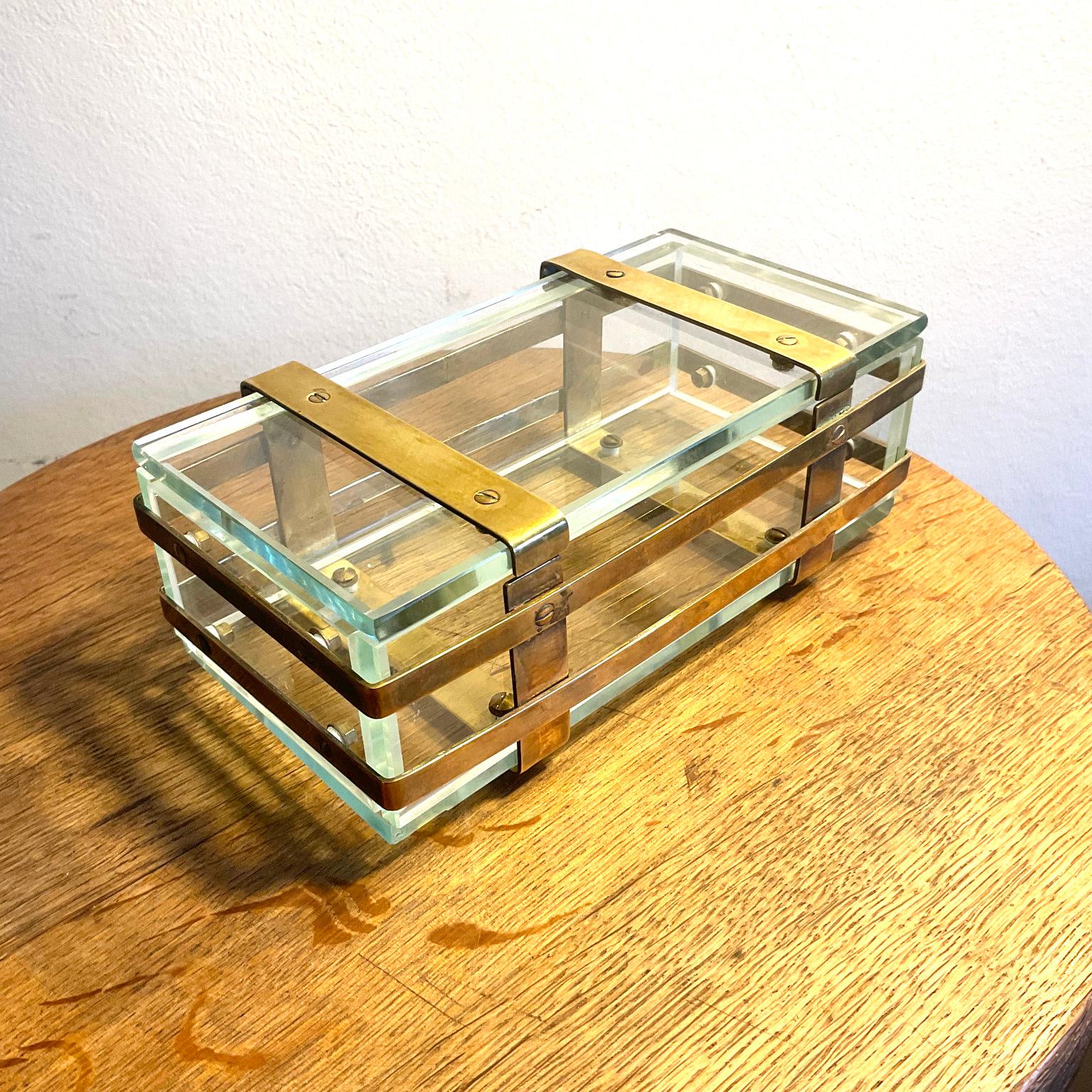Early 20th Century Art and Craft glass box, edged with brass belts forming a chest shape circa 1900
Acid-etched mark B
Exterior dimensions:
Height : 6cm
Width : 18cm
Depth : 10cm

Interior dimensions:
Height : 4.5cm
Width : 17cm
Depth : 7.5cm

