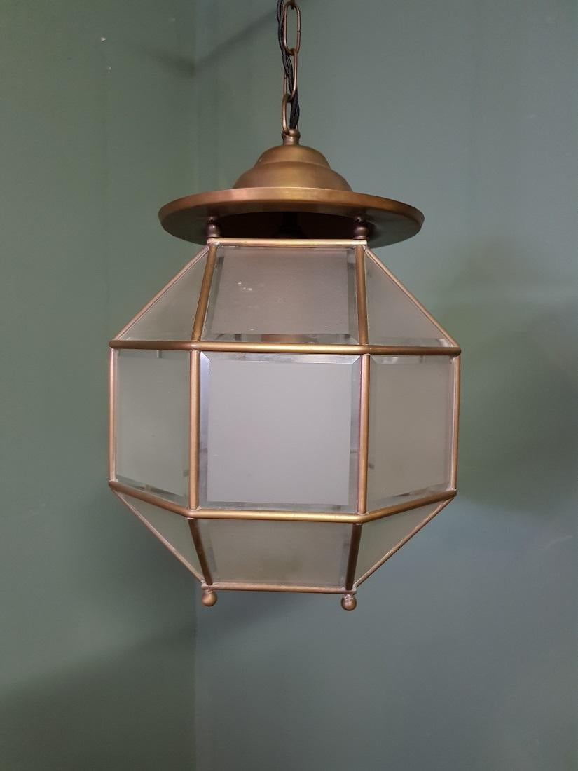 Excellent condition brass, bevelled and sanitized glass lantern.

This superb and stylish design is all handmade and in excellent condition. It has a total of twenty four rectangular, bevelled glass sections framed in brass and together they form