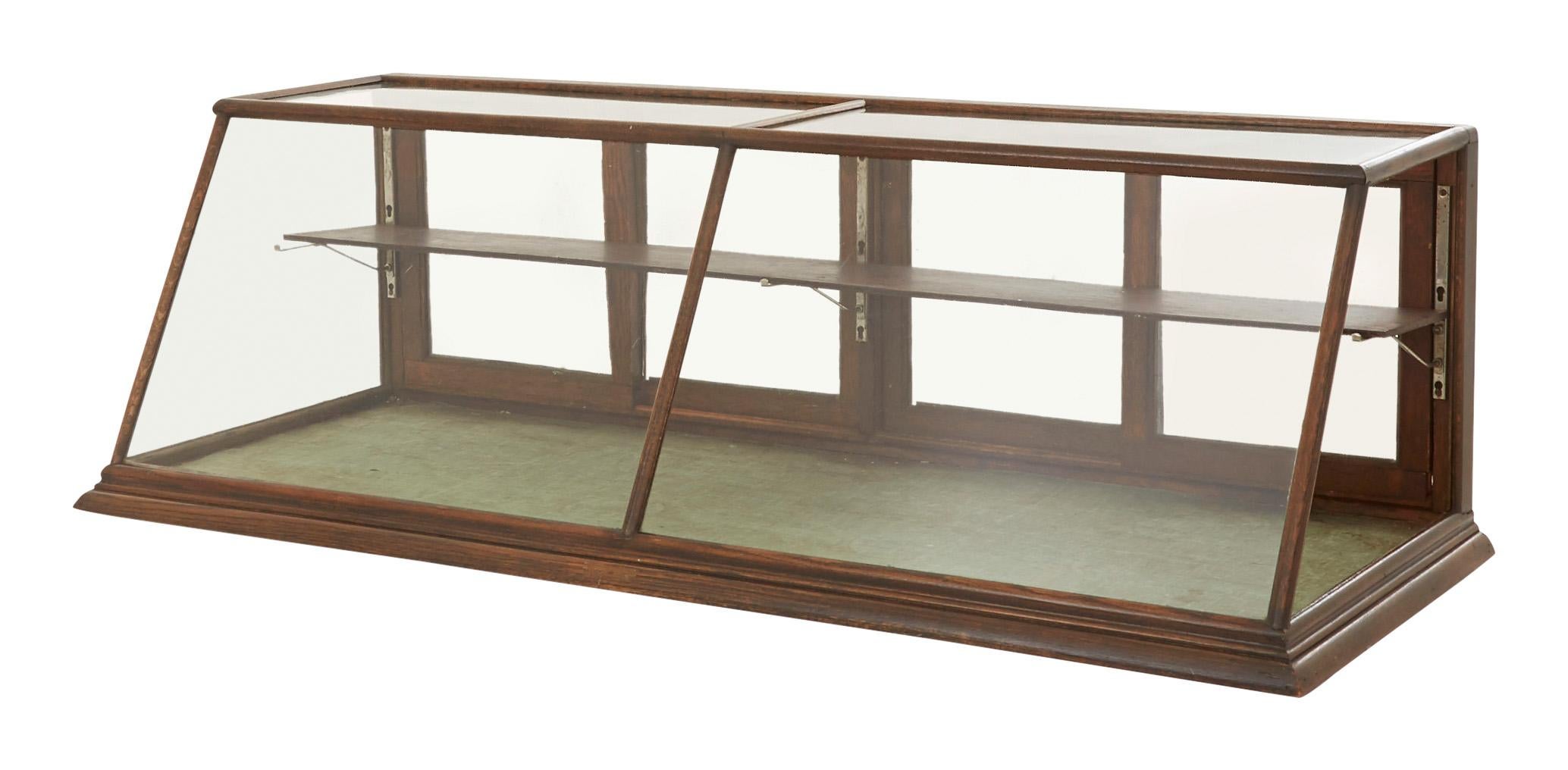 • Vintage mercantile tabletop display case
• Oak
• Glass sliding doors
• Wood shelf with adjustable brackets,
• Early 20th century,
• American
• Measures: 71