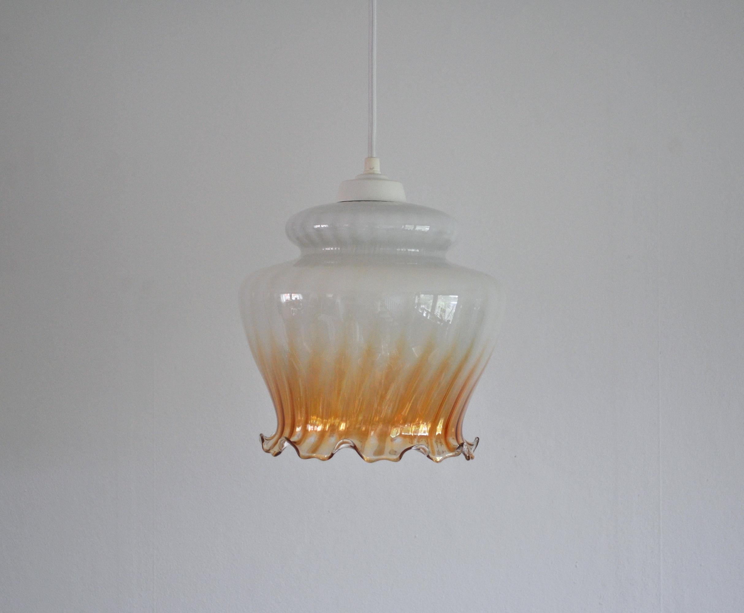 Glass pendant with decorative rim in Art Nouveau style. 
Probably made in Denmark.
Rewired with fabric cord. 
Diameter 22 cm, height 23 cm 
Light source: E27 Edison screw bulb.