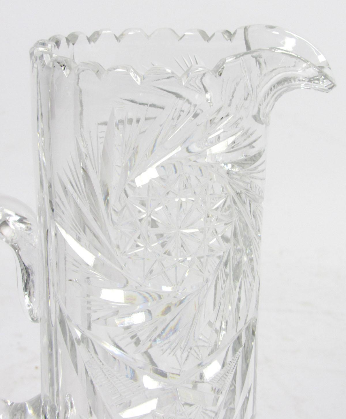 Early 20th century cut glass pitcher with handle.