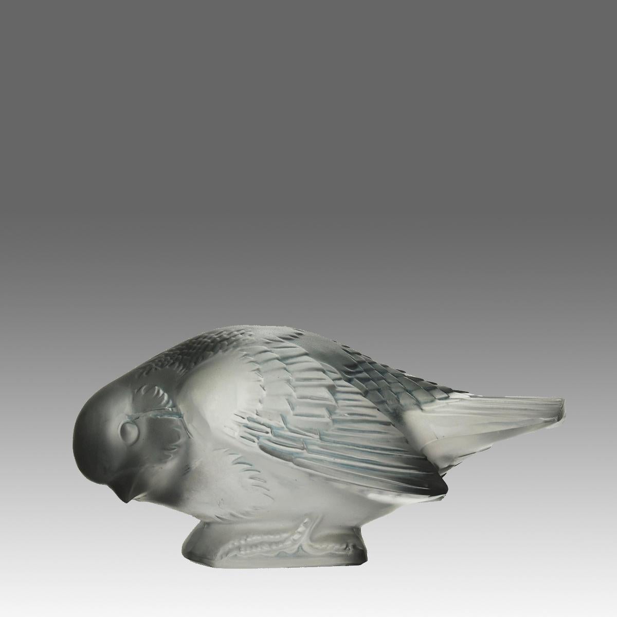 An endearing Art Deco clear glass study of a feeding sparrow with excellent hand finished surface detail, signed R.Lalique.

