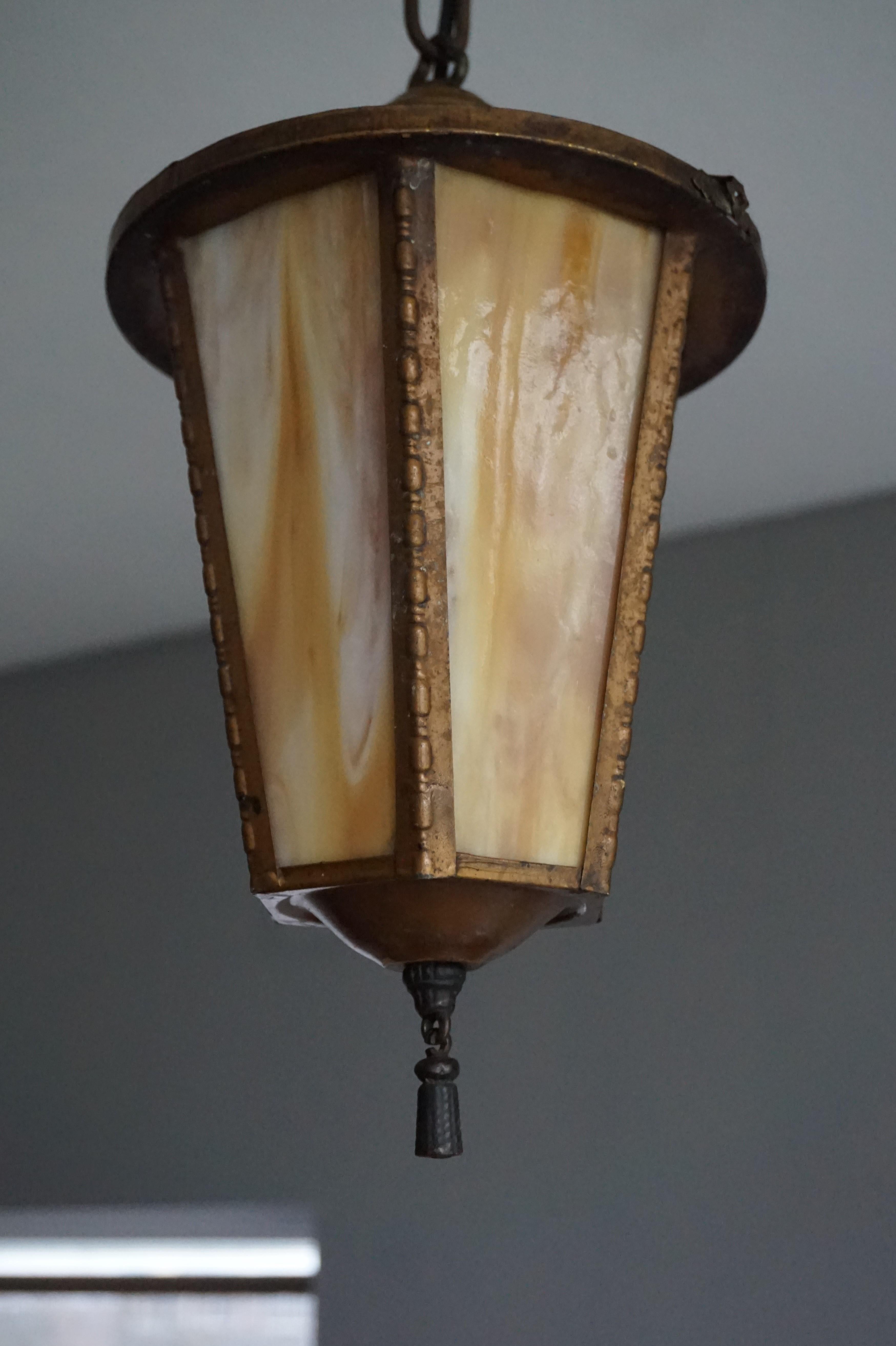 Small church entrance light fixture with a cast iron tassel.

The former owners told us that this rare and all-original light fixture once was on the ceiling at the entrance of a small Gothic Revival church. The hook that connects the pendant and