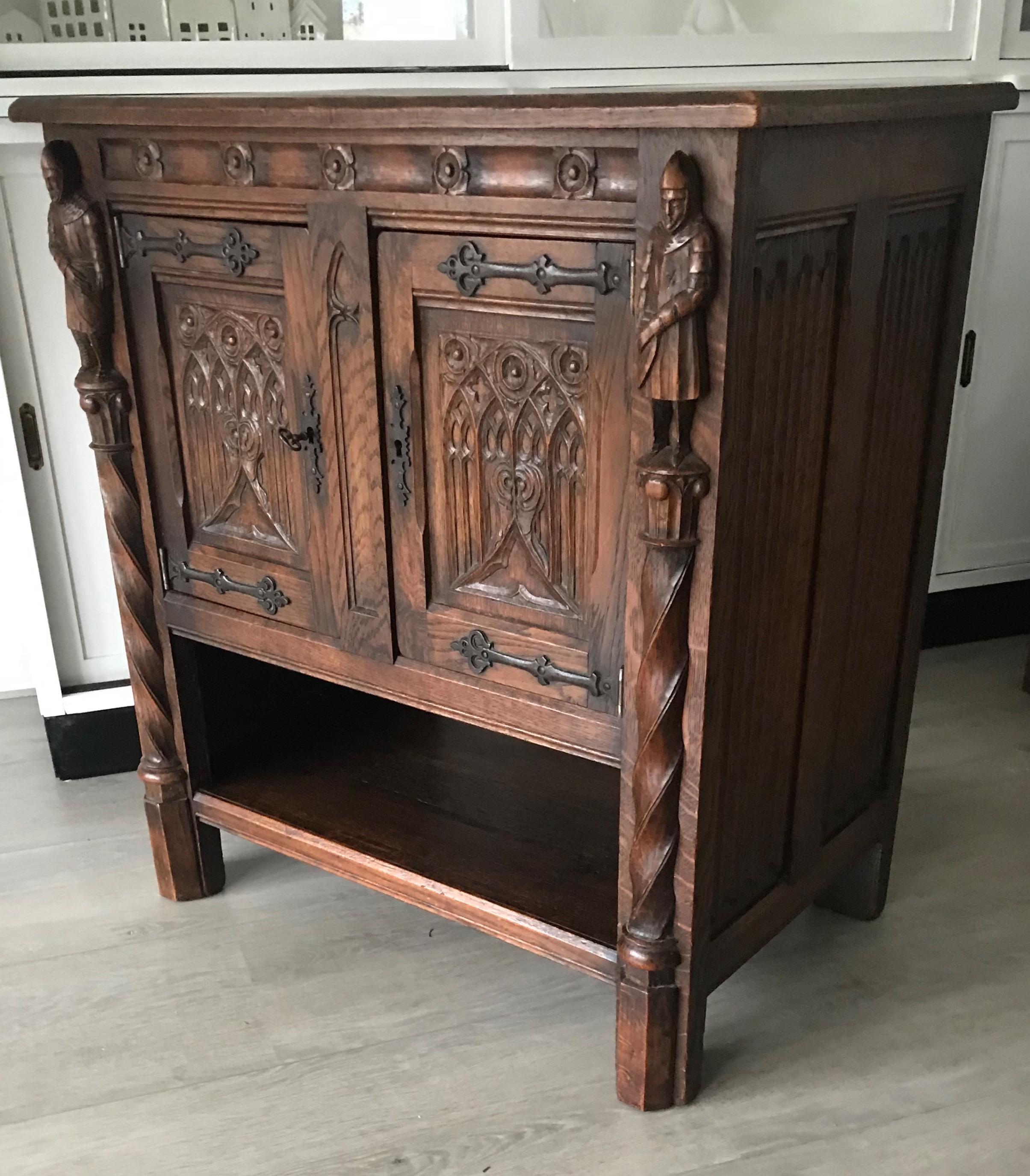 Marvellous and practical Gothic Revival drinks cabinet. 

This rare, Dutch Gothic dry bar is in excellent condition. This beautifully carved cabinet comes with two Knights who look like they are guards to the gate of a castle. The doors to this