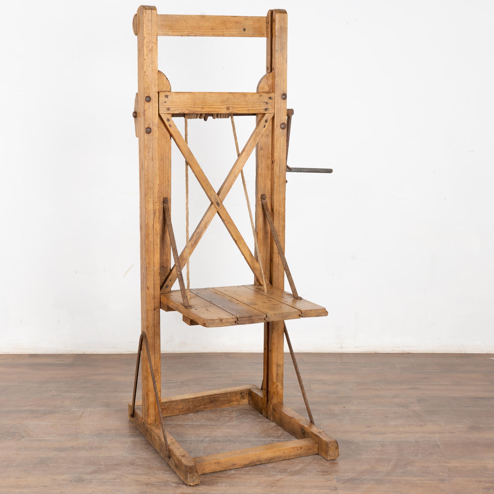 This old vintage grain lift has been restored and waxed, bringing out the warm patina of the wood. 
As seen in photos, this can be raised and lowered creating unique display options. Original ropes and metal support rods in place.
Restored and