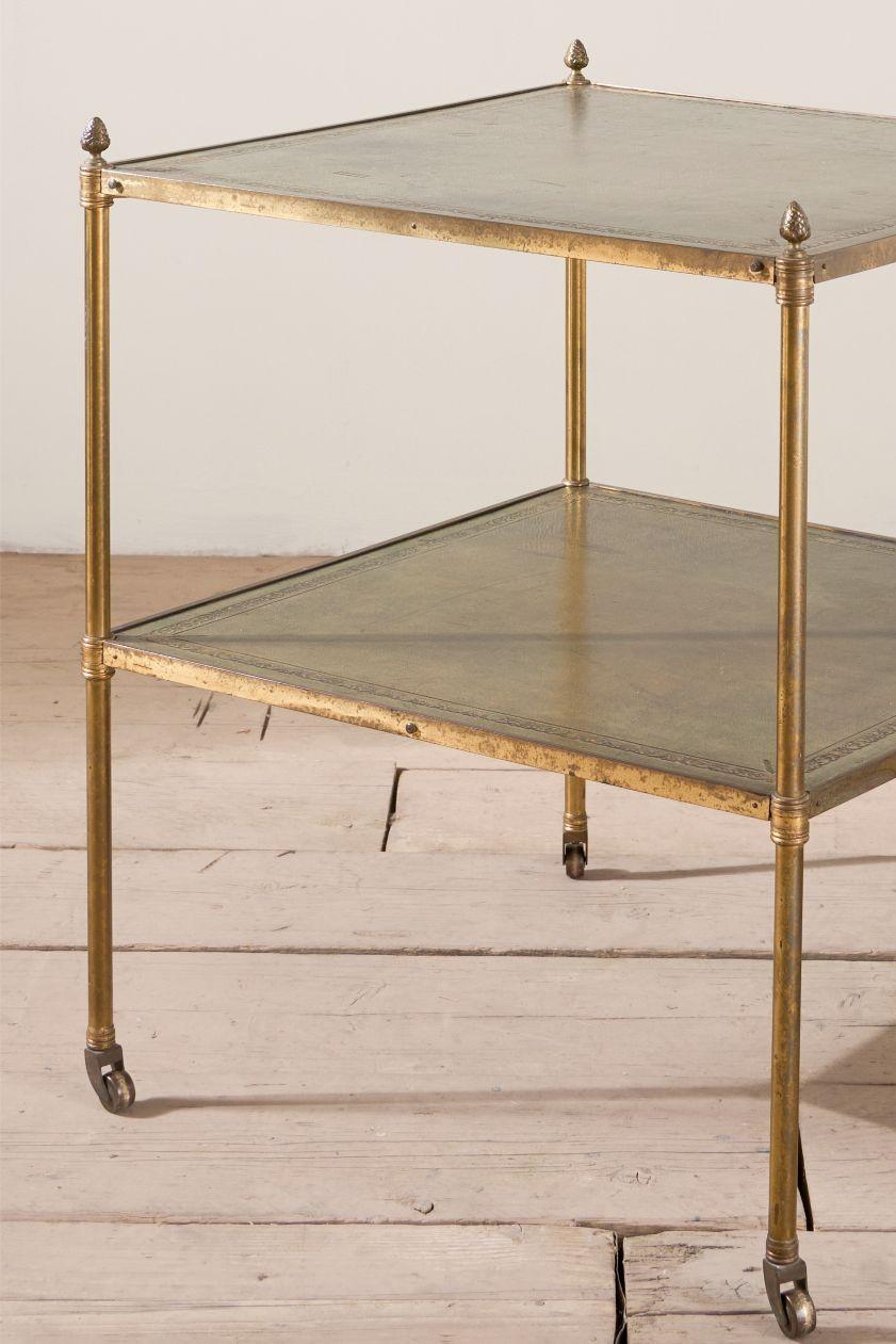 This is a very stylish original early 20th century brass and green leather side table. Found in a Yorkshire stately home and looking even better for all its years of use. The leather colour and patina is superb and overall condition very good. With