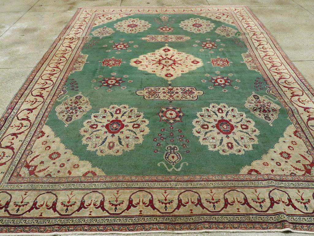 Indian Early 20th Century Green, Red, and Beige Distressed Rug For Sale