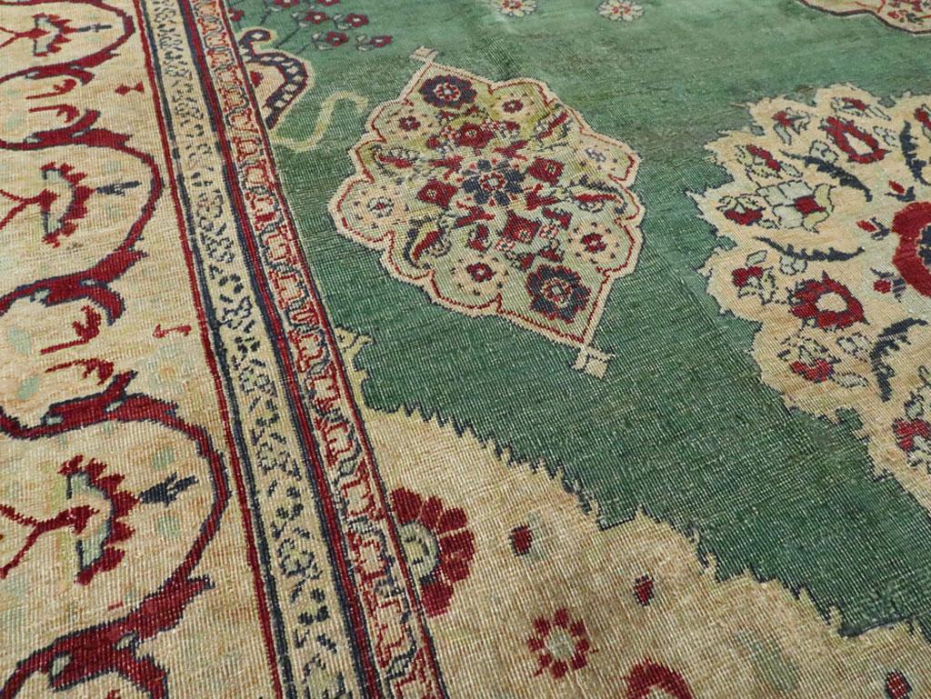Hand-Knotted Early 20th Century Green, Red, and Beige Distressed Rug For Sale