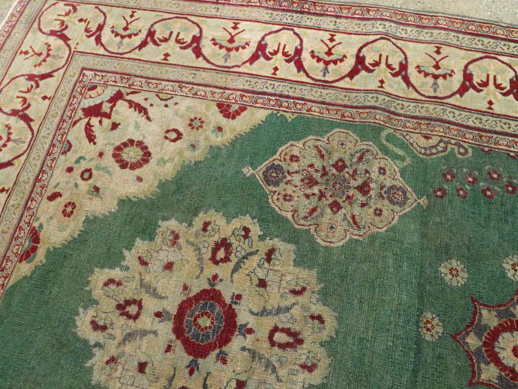 Early 20th Century Green, Red, and Beige Distressed Rug In Fair Condition For Sale In New York, NY