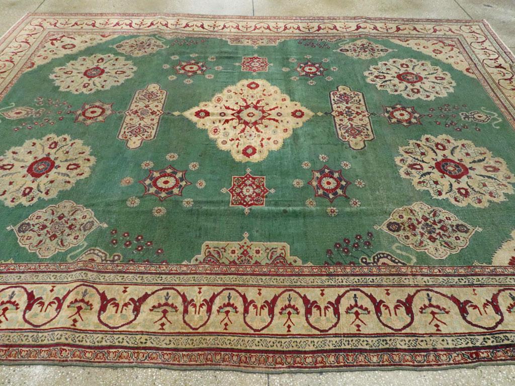 Wool Early 20th Century Green, Red, and Beige Distressed Rug For Sale